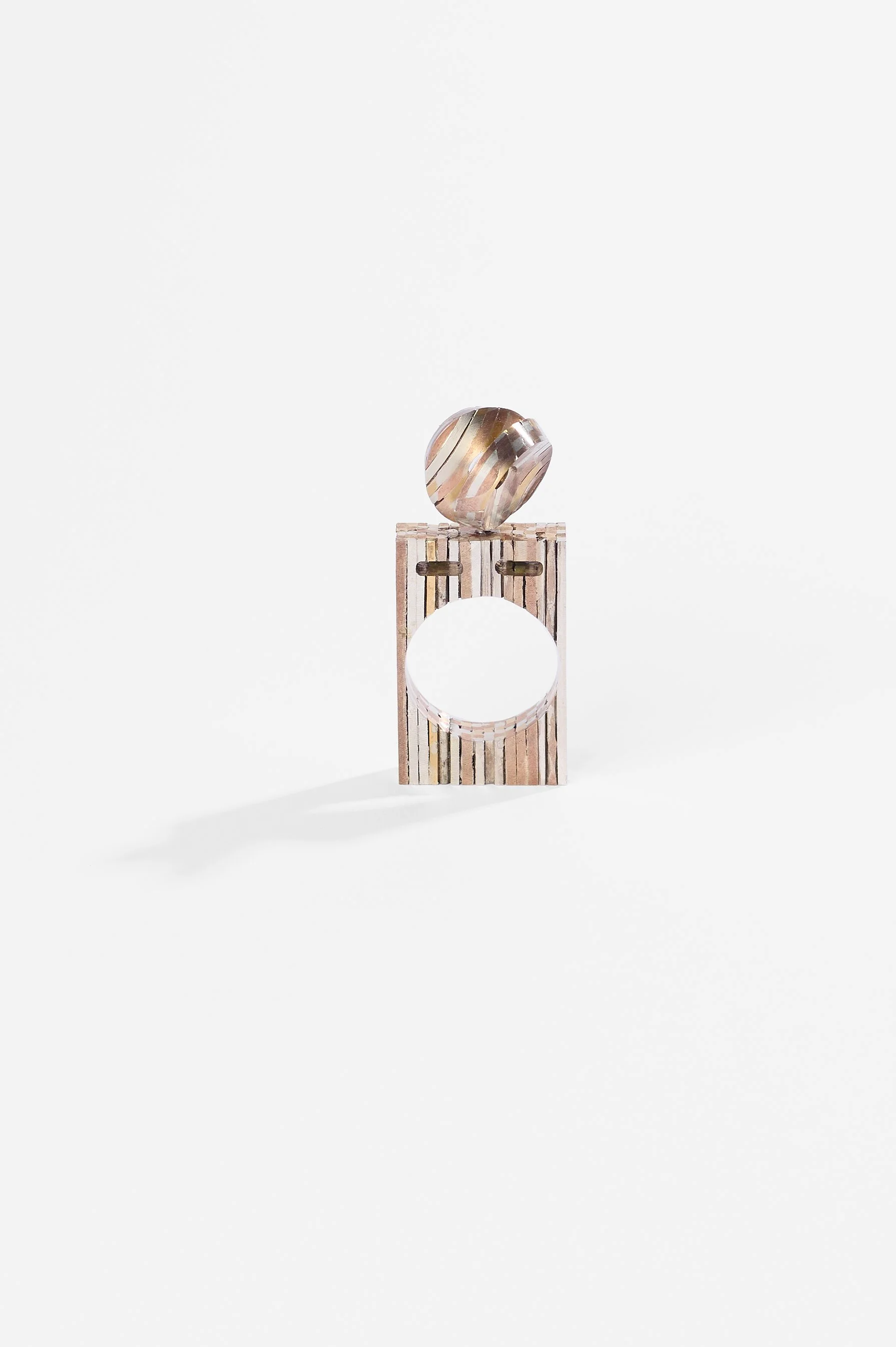 Helen Dilkes, Metal alloys puffy self-intersecting surface finger sculpture, 24kt gold, 999 silver, 925 silver, shakudo, shibuichi, green diamonds, 65 x 25 x 6mm, 2015-2026, $3,500. Photography: Ross Coulter