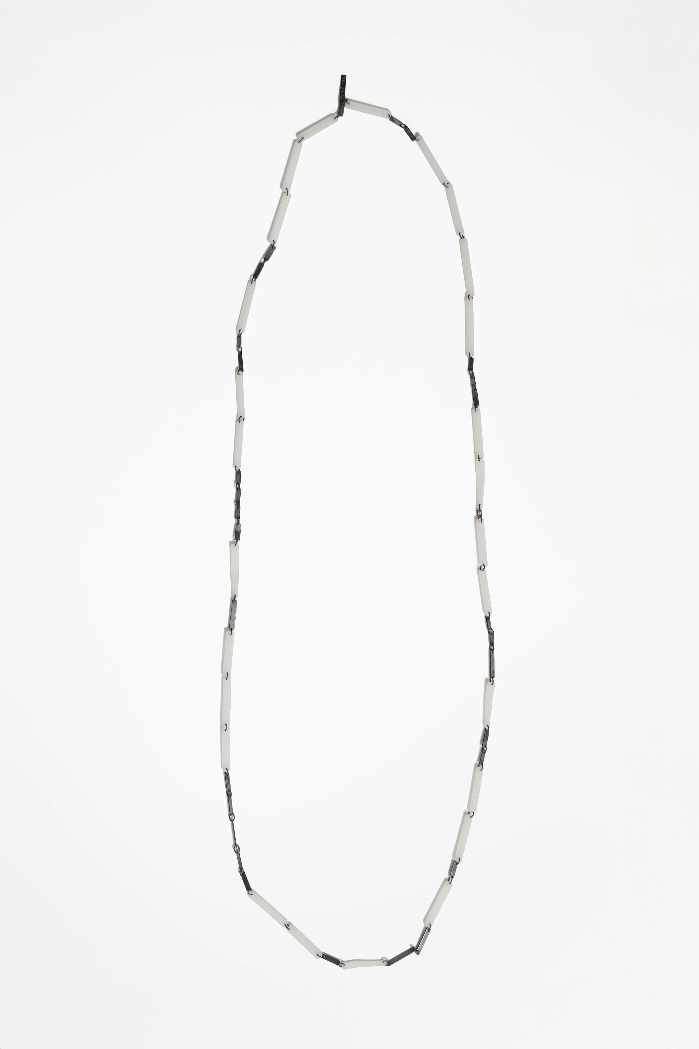 55. Melissa Cameron, ‘rapidly #c – chain’, 2024, found steel street sweeper blades, recycled nylon zip ties, stainless steel chain links, brushed steel, 110cm chain. Price: $400