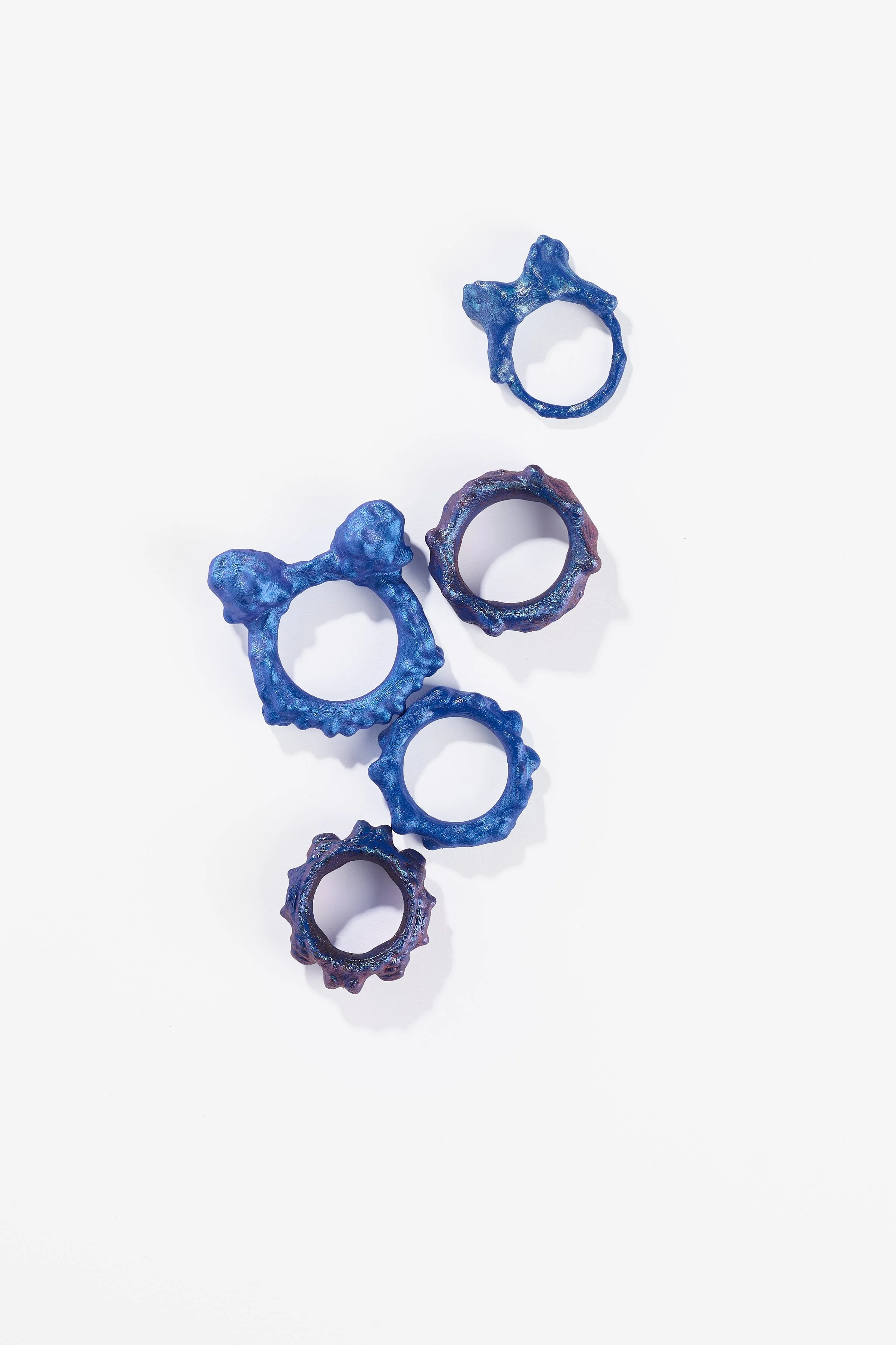 Debris Facility, Capsule Collapsing, oxidised silver, surgical stainless steel, aluminium, 3D printed nylon, anodised stainless steel, printed acetate, mirror frame, acrylic display, acrylic paint, iridescent pigment, 2026. $365 + cost of production;