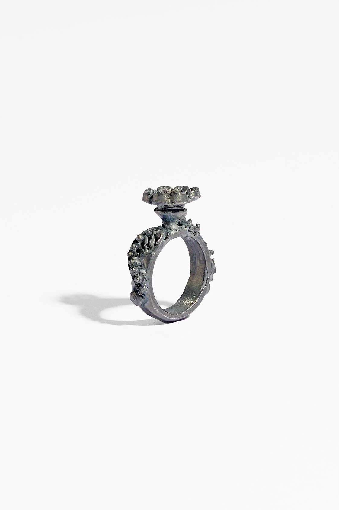 Laila Marie Costa, Untitled 19 (grey ring horizontal flower on top), recycled sterling silver (oxidised) and grey diamond powder, 2.5 x 3.5 x 1.5cm, 11.7gms, $1500. Photography: Ross Coulter