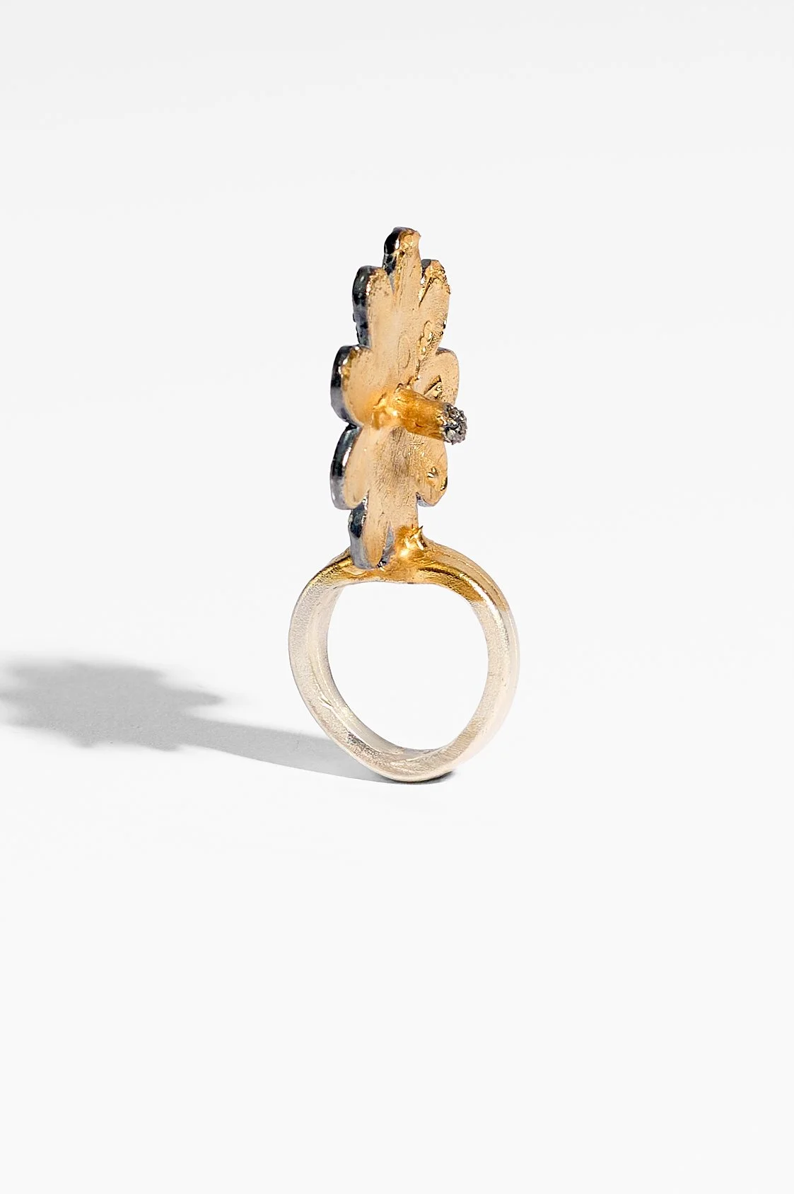 Laila Marie Costa, Untitled 1 (large gold sideways flower with stamen), sterling silver, gold plating, oxidisation, black diamond powder, 3.5 x 5.5 x 2cm, 19.7gms, $1500. Photography: Ross Coulter
