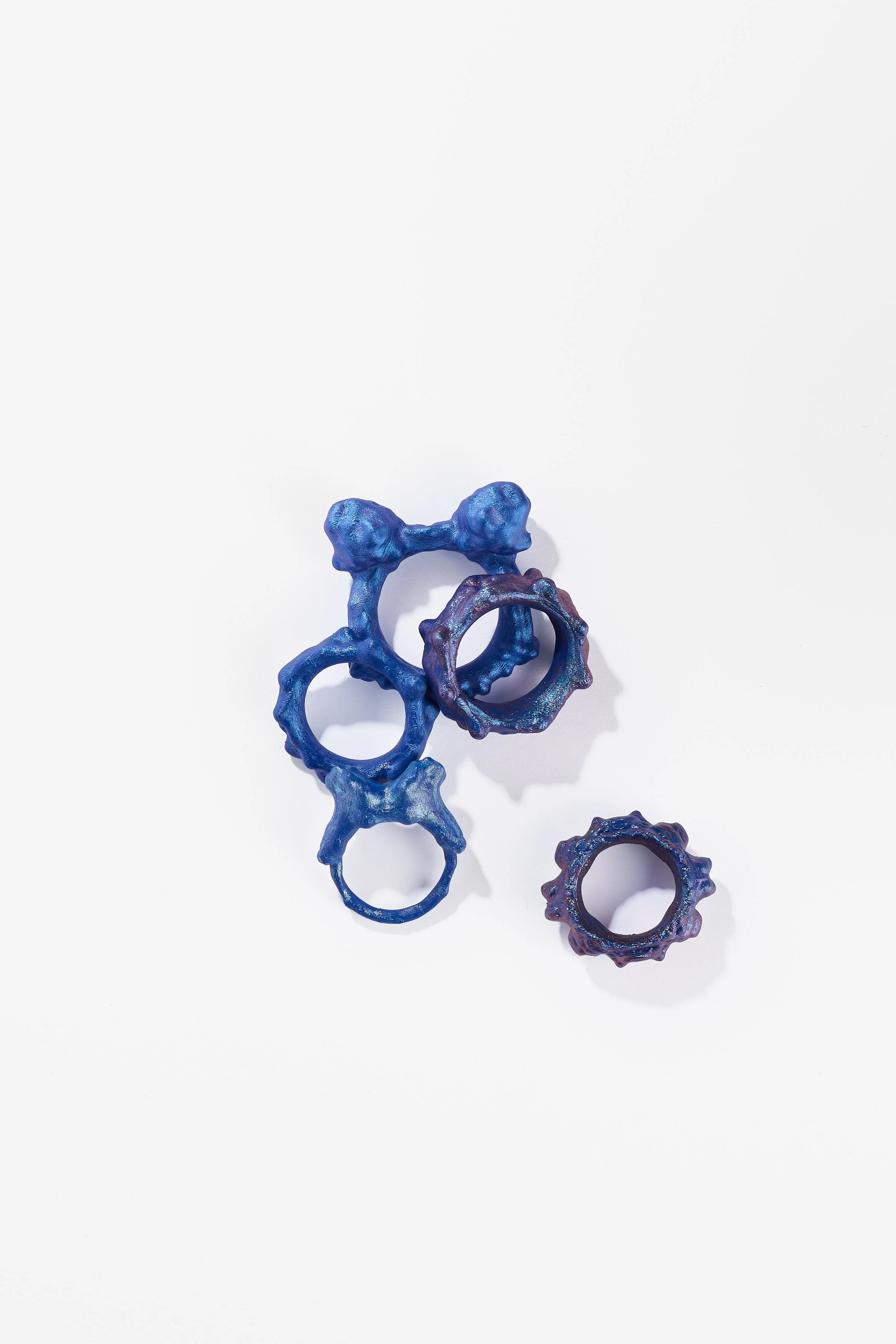 Debris Facility, Capsule Collapsing, oxidised silver, surgical stainless steel, aluminium, 3D printed nylon, anodised stainless steel, printed acetate, mirror frame, acrylic display, acrylic paint, iridescent pigment, 2026. $365 + cost of production;