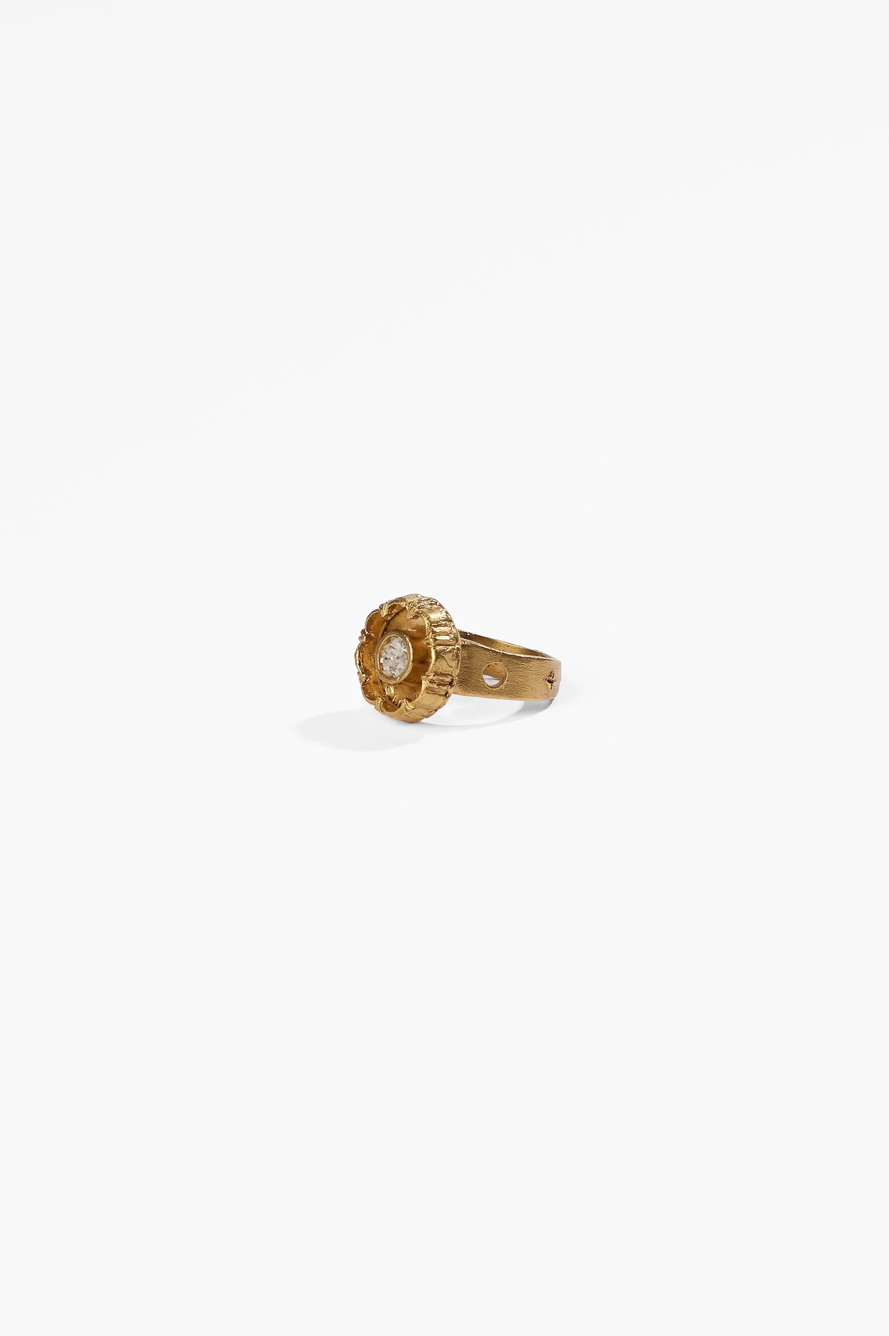 Laila Marie Costa, Untitled 23 (gold sconced flower design, internal circle setting), bronze (gold plated) and white diamond powder, $1000. Photography: Ross Coulter