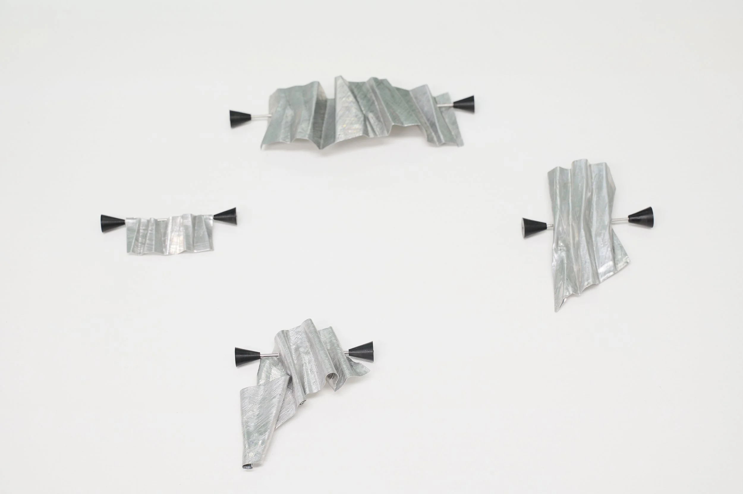 Tom Burless, 'Kekkai Shroud - Brooch #1 - #4', aluminium, stainless steel, acetal, 10 x 7 x 2.5 (approx.) each, installation view, Alta Forma, Naarm/Melbourne, 2026. Photograph: Ross Coulter
