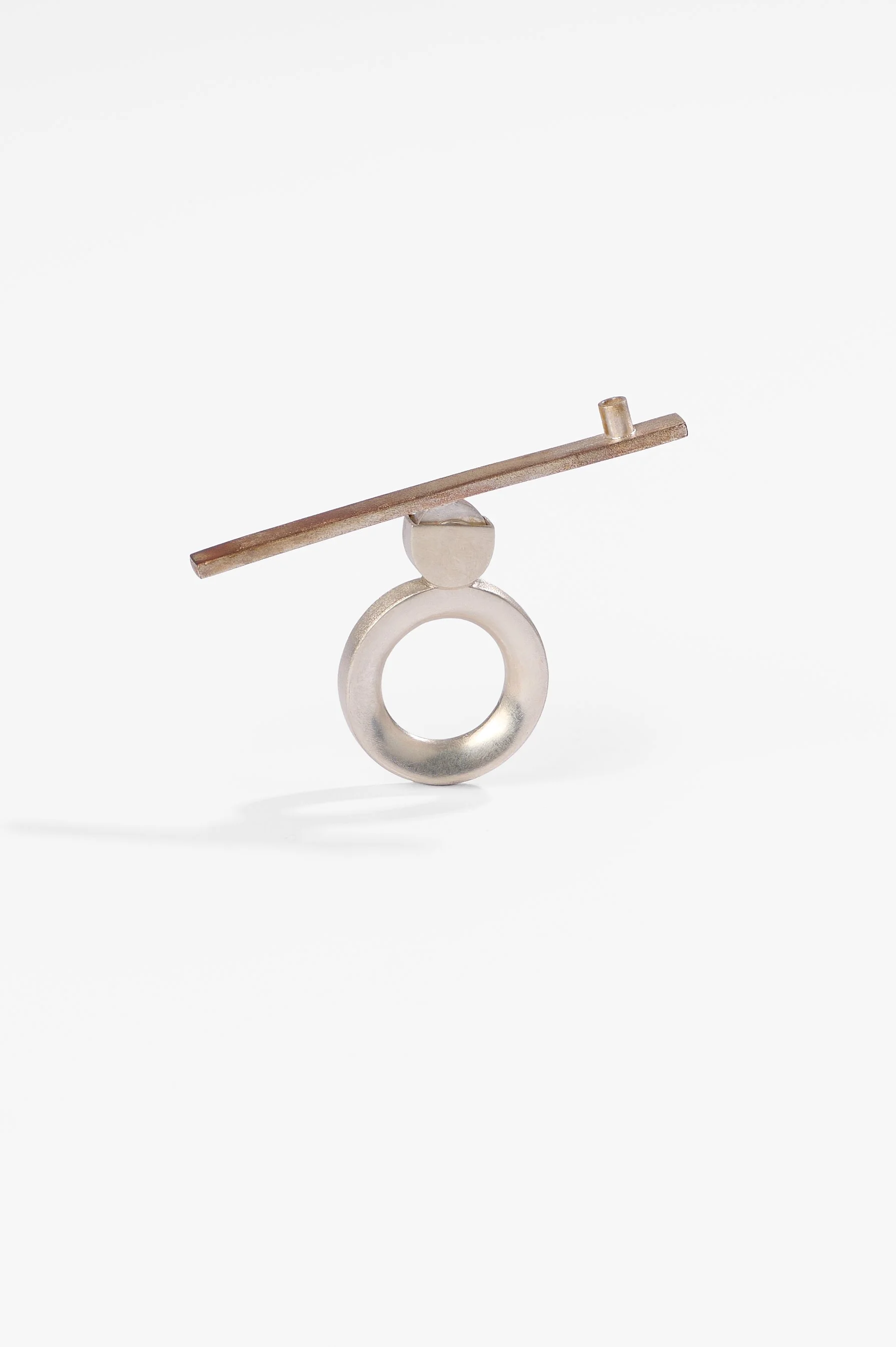 Thao Bui, See saw, sterling silver, shibuichi, 42mm x 69.5mm, 2026, $2,100 Photography: Ross Coulter