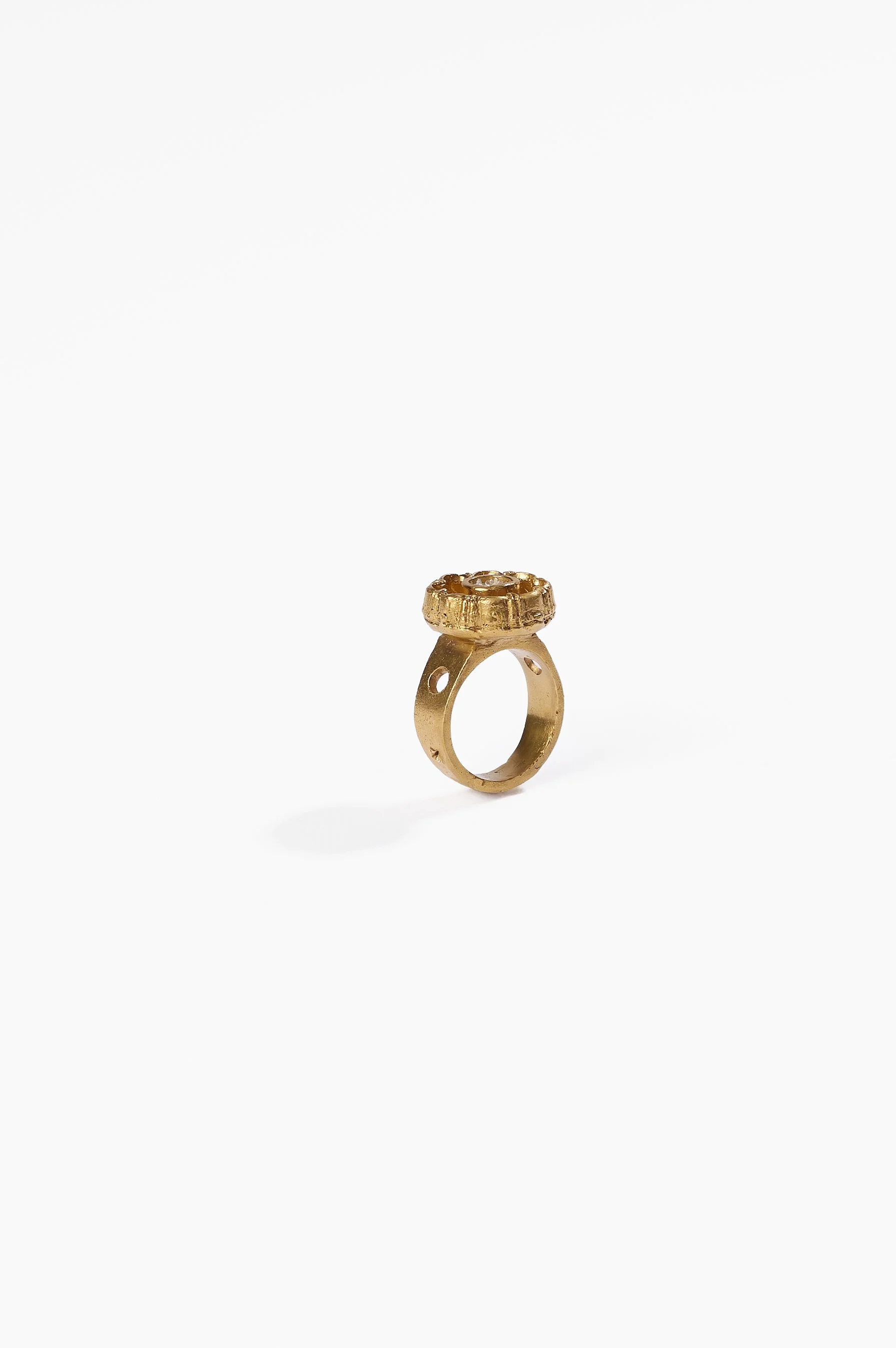 Laila Marie Costa, Untitled 23 (gold sconced flower design, internal circle setting), bronze (gold plated) and white diamond powder, $1000. Photography: Ross Coulter
