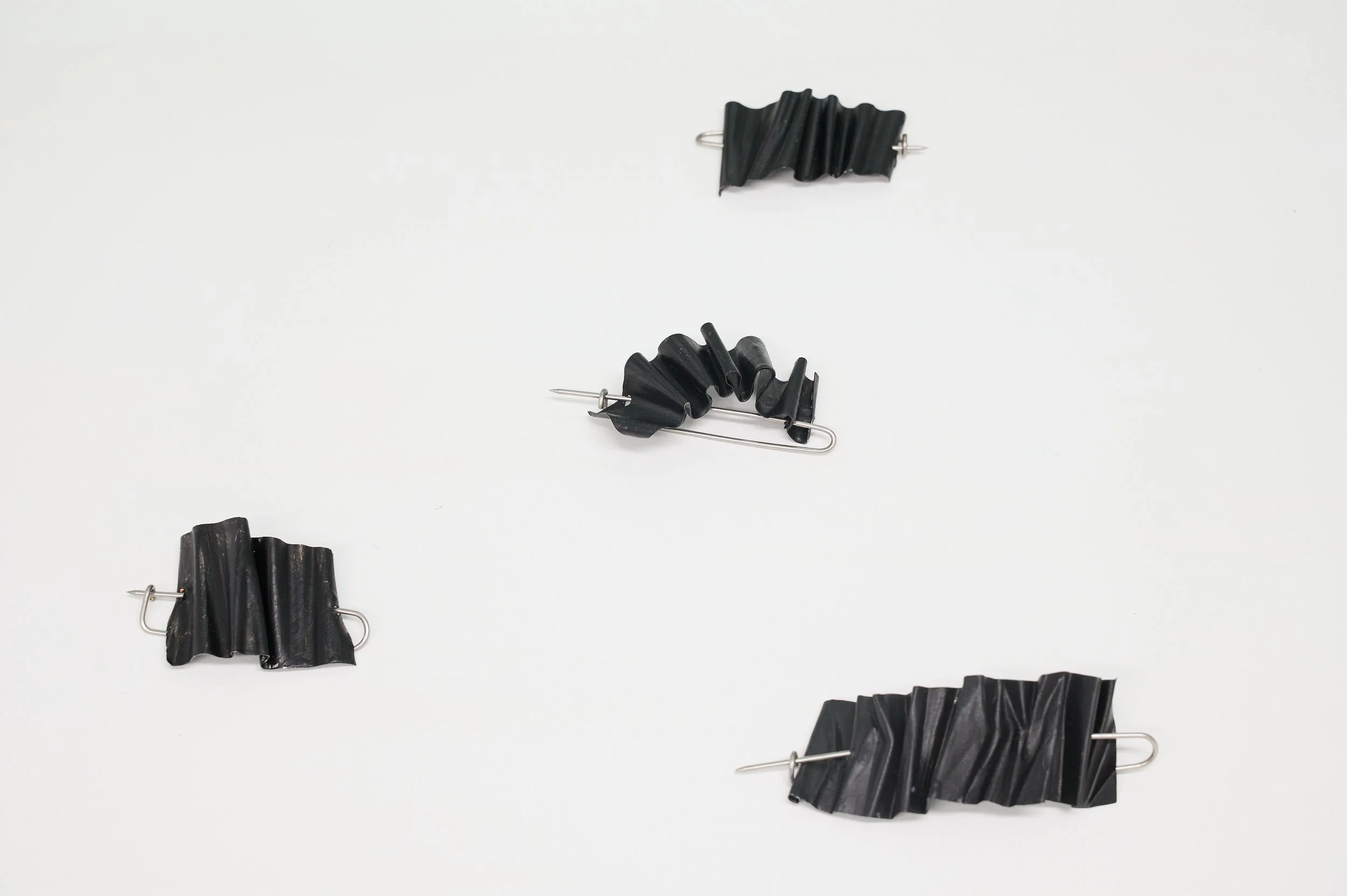 Tom Burless, 'Kekkai Shroud - Brooch #1 - #4', aluminium, stainless steel, paint, 10 x 7 x 2.5 (approx.) each, installation view, Alta Forma, Naarm/Melbourne, 2026. Photograph: Ross Coulter