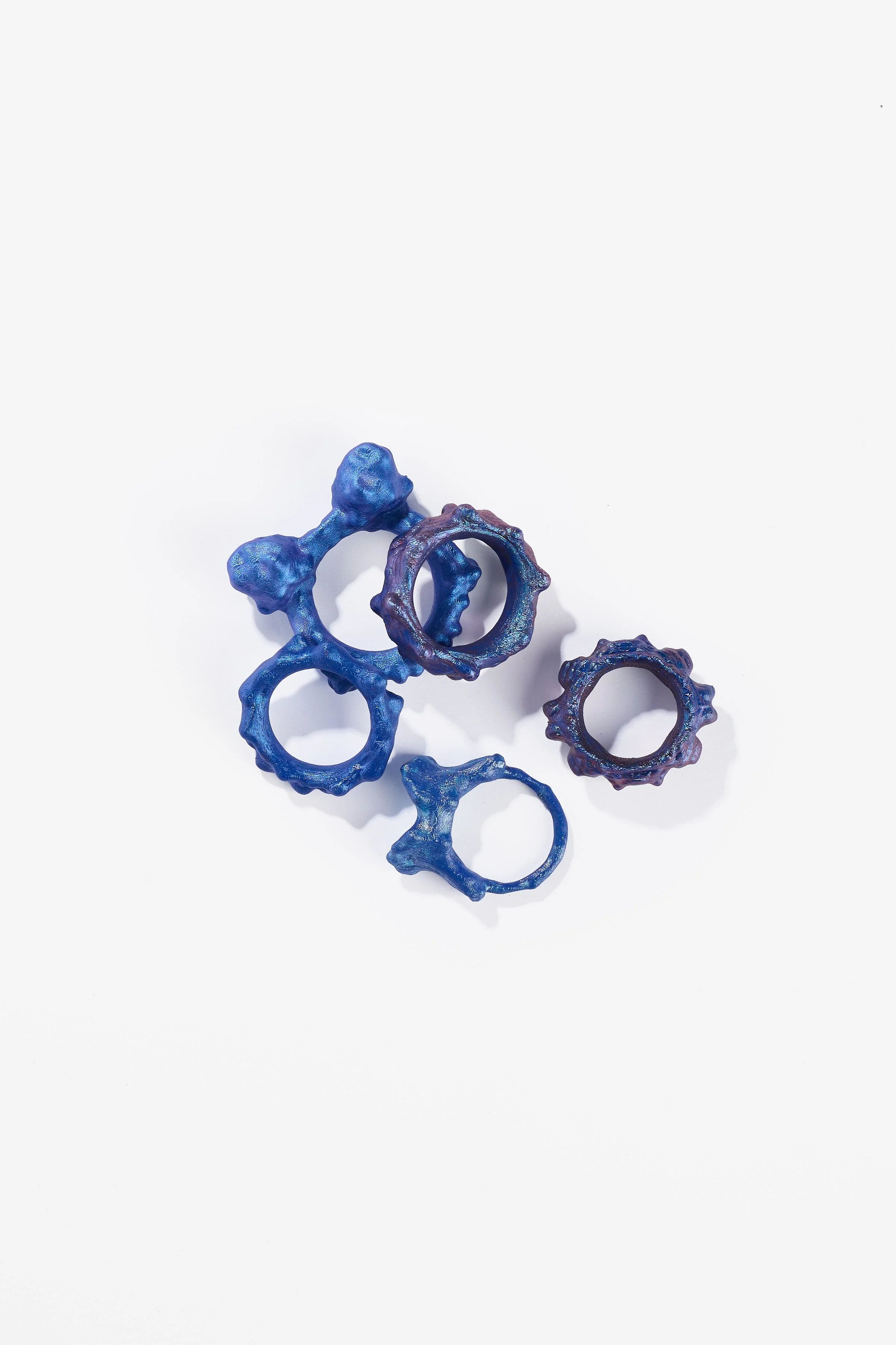 Debris Facility, Capsule Collapsing, oxidised silver, surgical stainless steel, aluminium, 3D printed nylon, anodised stainless steel, printed acetate, mirror frame, acrylic display, acrylic paint, iridescent pigment, 2026. $365 + cost of production;