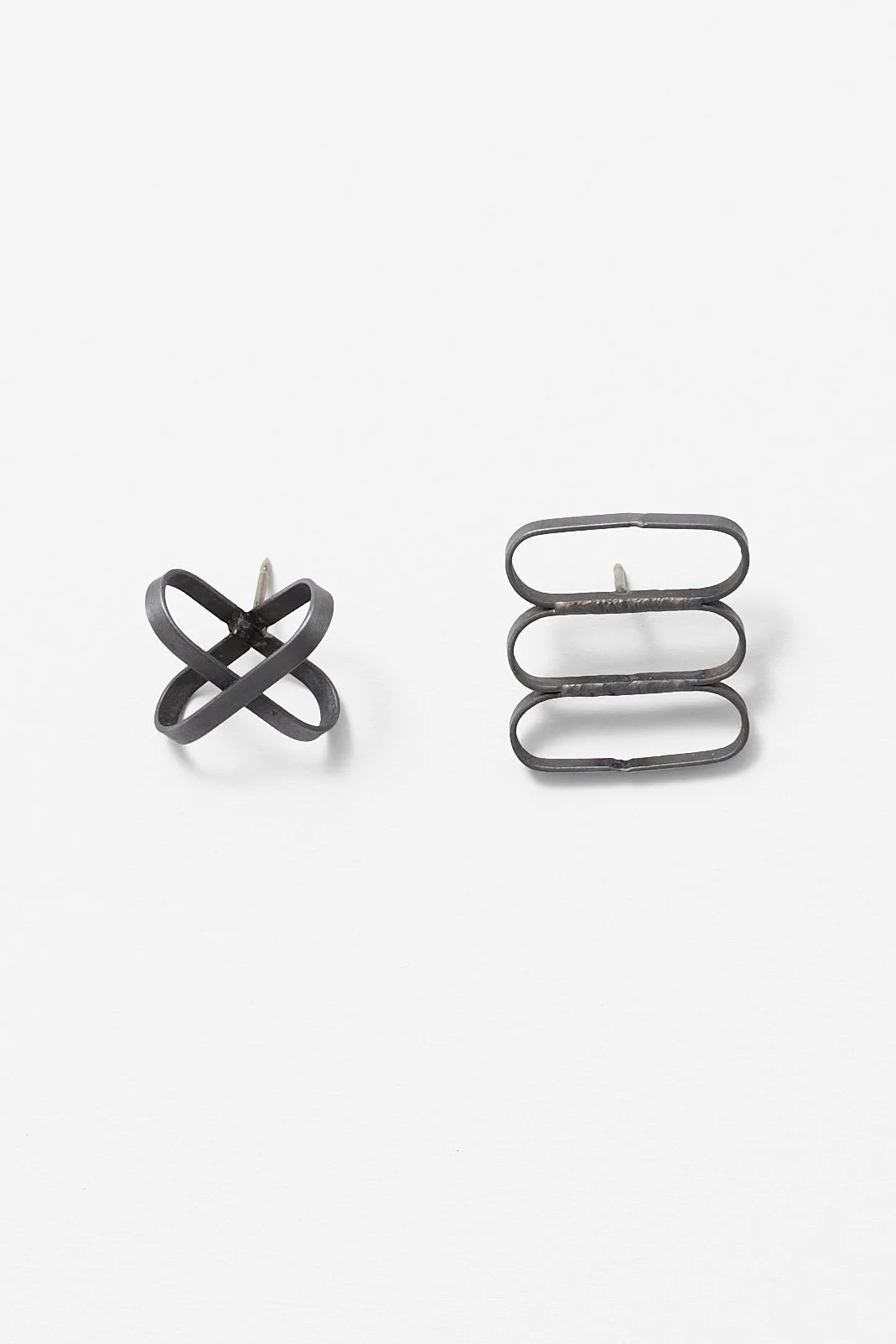 48. Melissa Cameron, left: ‘Sweeper Blade Cross Pin’, 2025, found steel street sweeper blades, nickel silver pin, waxed brushed finish, 2.7x2.7x 2cm. Price: $180; right, ‘Sweeper Blade 3 link pin’, 2025, found steel street sweeper blades, nickel silv