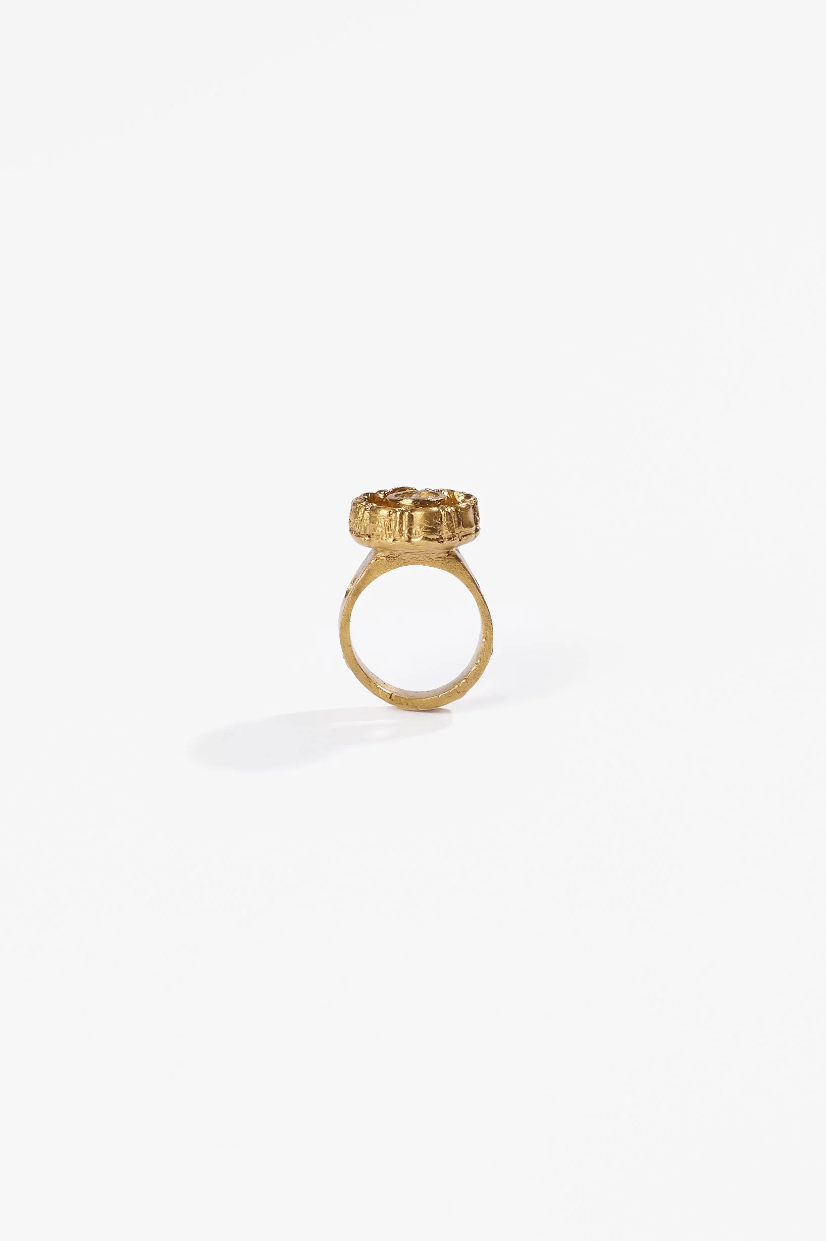 Laila Marie Costa, Untitled 23 (gold sconced flower design, internal circle setting), bronze (gold plated) and white diamond powder, $1000. Photography: Ross Coulter