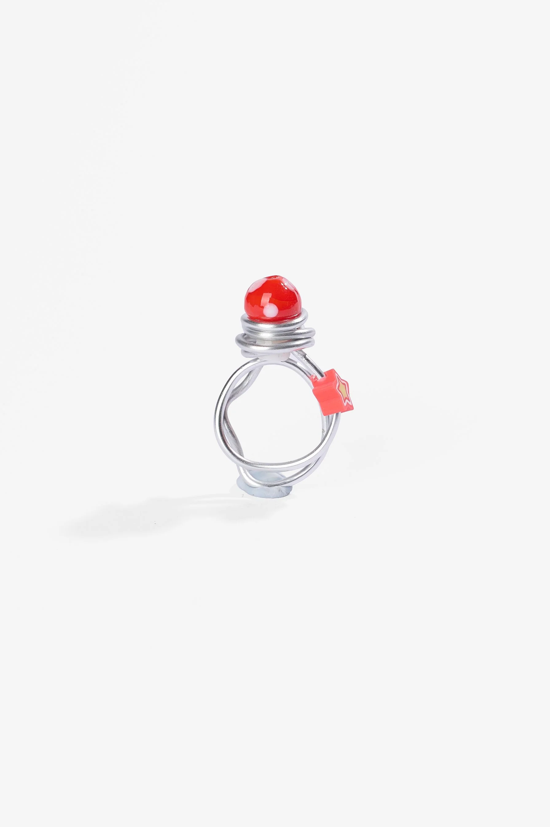 Roma Turnbull-Coulter, Red ring, aluminium wire, plastic and glass beads, 2026, $75. Photography: Ross Coulter