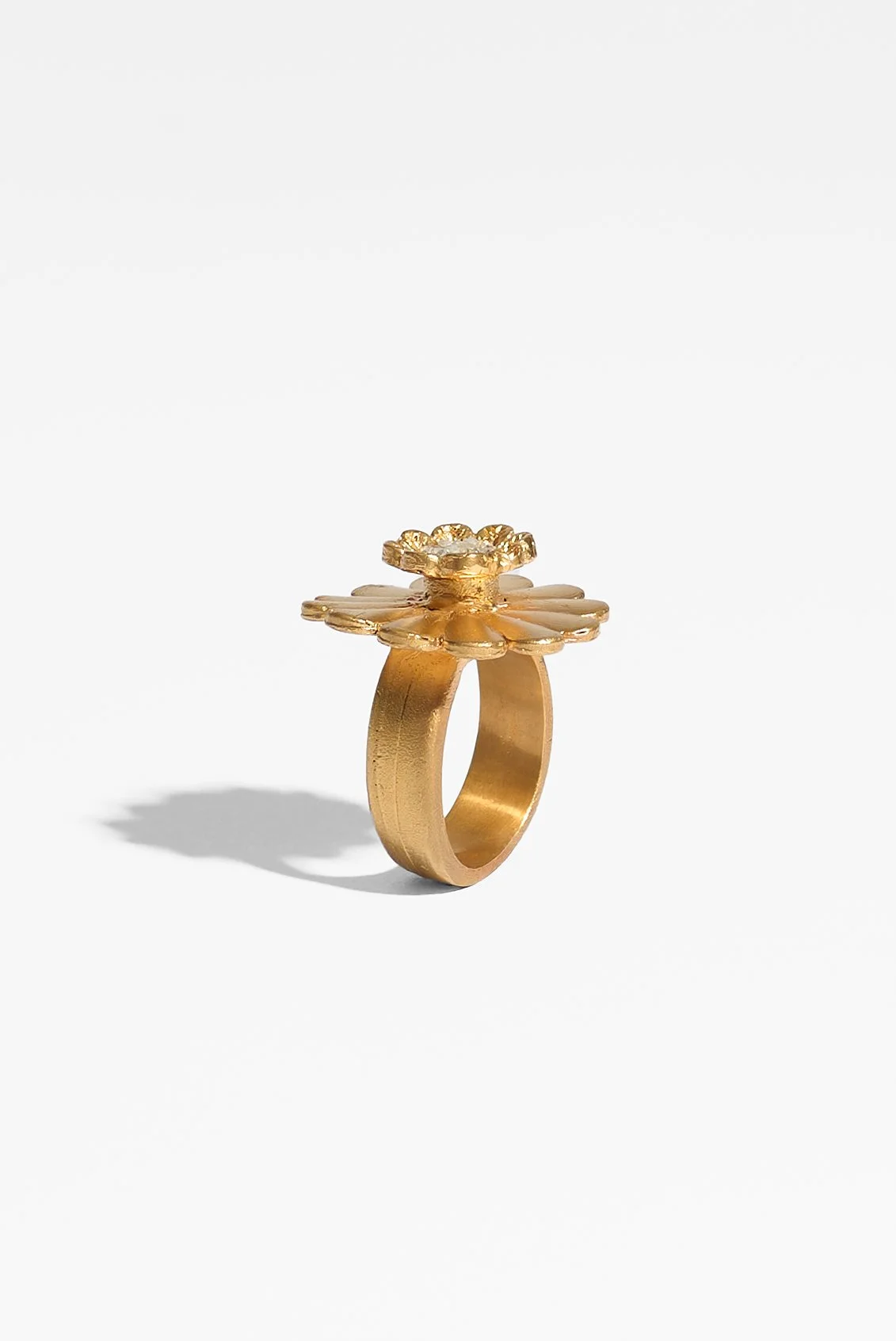 Laila Marie Costa, Untitled 14 (large gold dual flower large daisy shape plus smaller flower horizontal), bronze (gold plated) and white diamond powder, 3 x 3 x 3cm, 14.5 grams, $1100. Photography: Ross Coulter
