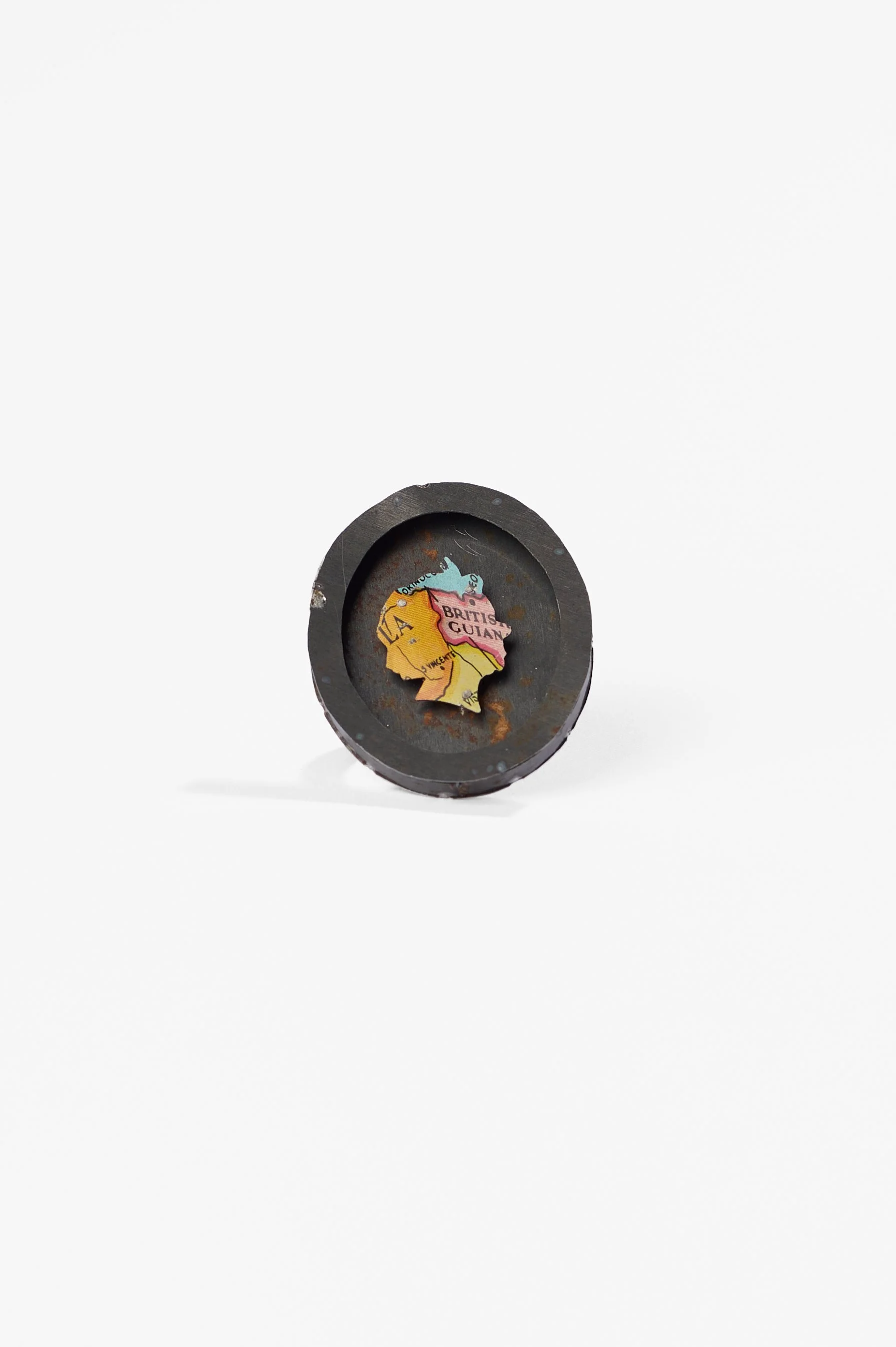 Anna Davern. 'Empire ring (British Guiana)', biscuit tin, tin globe, 40x35x22mm size , 2026, $380. Photography: Ross Coulter