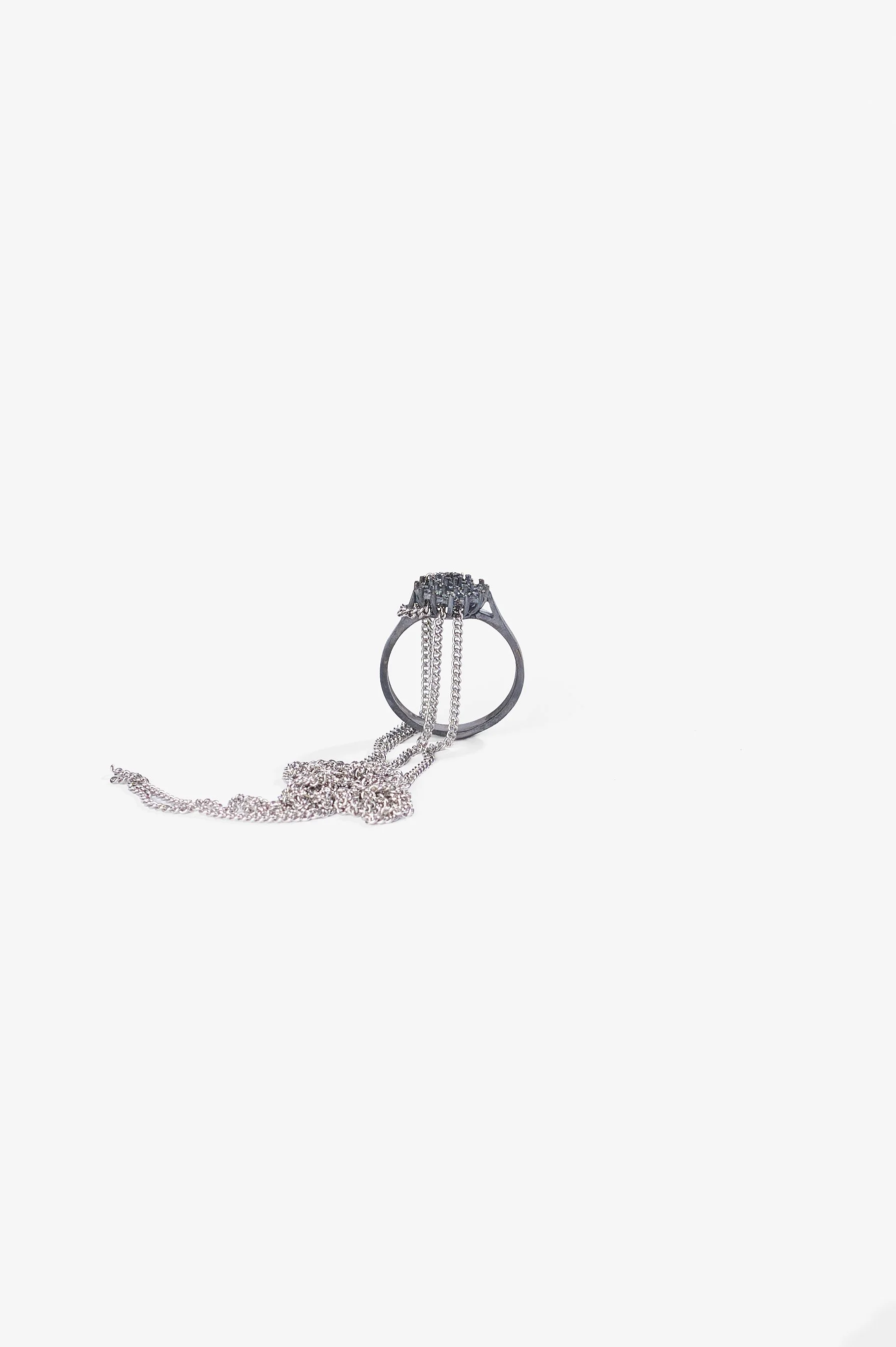 Debris Facility, Capsule Collapsing, oxidised silver, surgical stainless steel, aluminium, 3D printed nylon, anodised stainless steel, printed acetate, mirror frame, acrylic display, acrylic paint, iridescent pigment, 2026. Metal rings $365 each. Pho