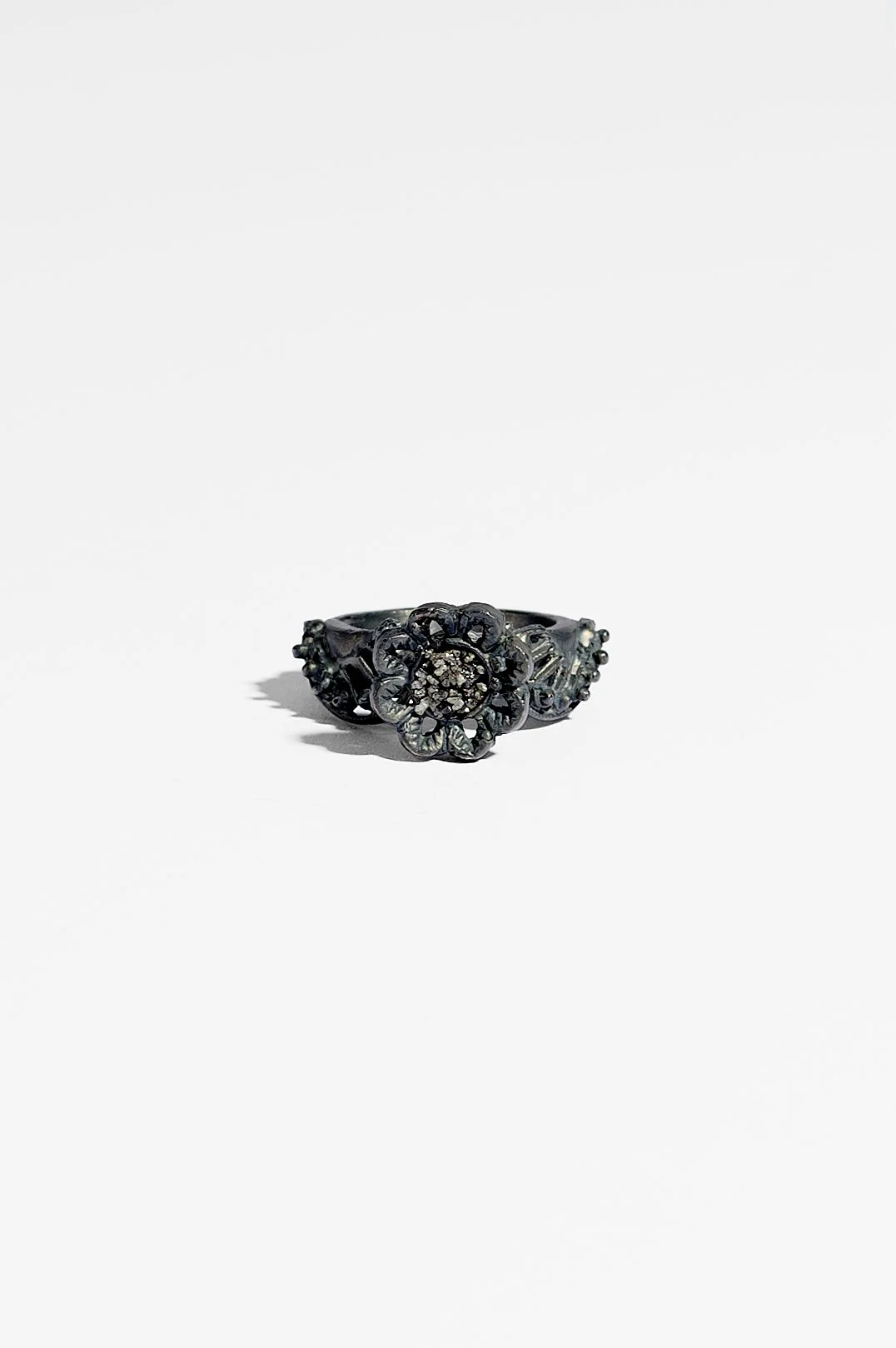 Laila Marie Costa, Untitled 19 (grey ring horizontal flower on top), recycled sterling silver (oxidised) and grey diamond powder, 2.5 x 3.5 x 1.5cm, 11.7gms, $1500. Photography: Ross Coulter