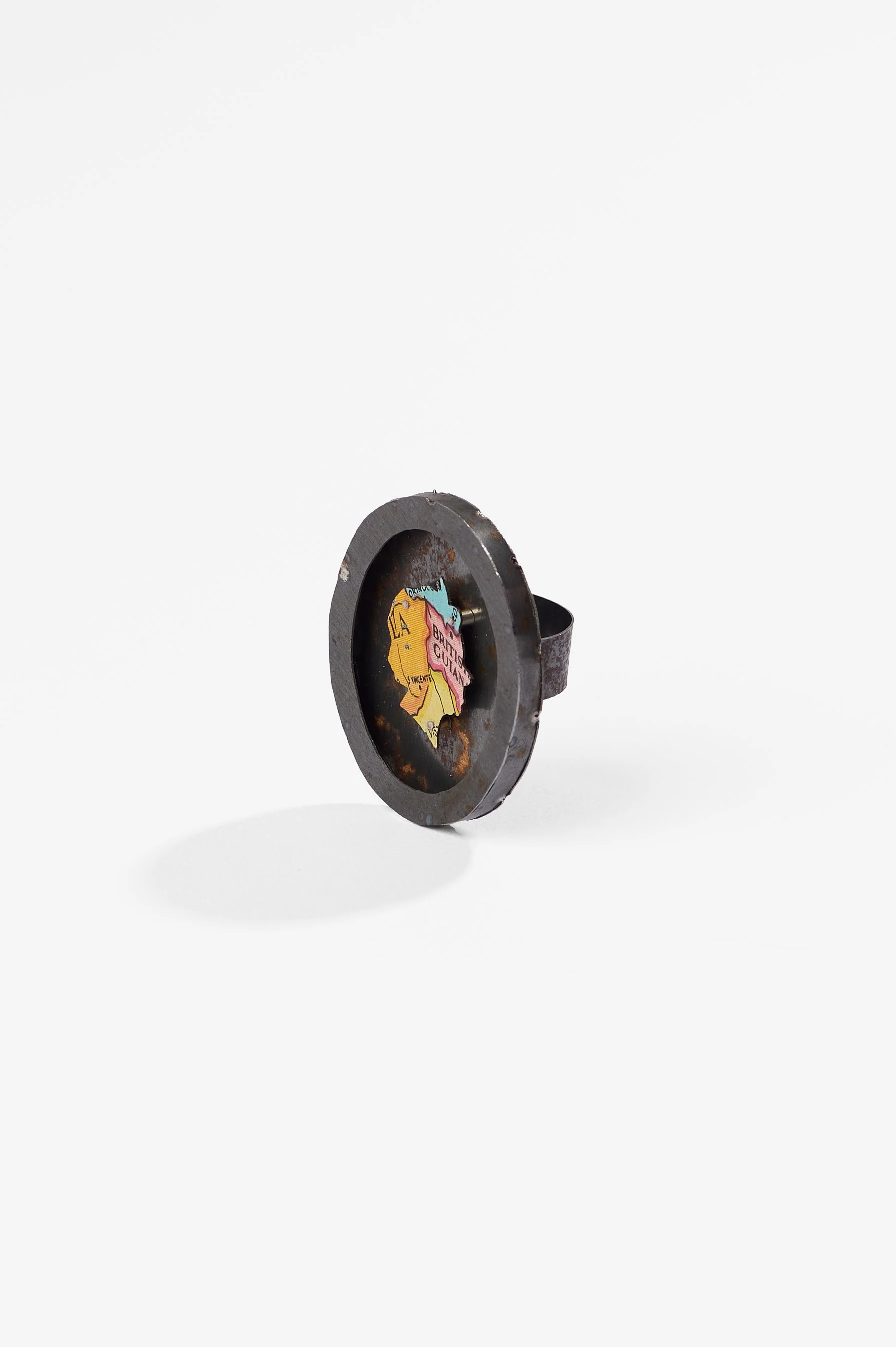 Anna Davern. 'Empire ring (British Guiana)', biscuit tin, tin globe, 40x35x22mm size , 2026, $380. Photography: Ross Coulter