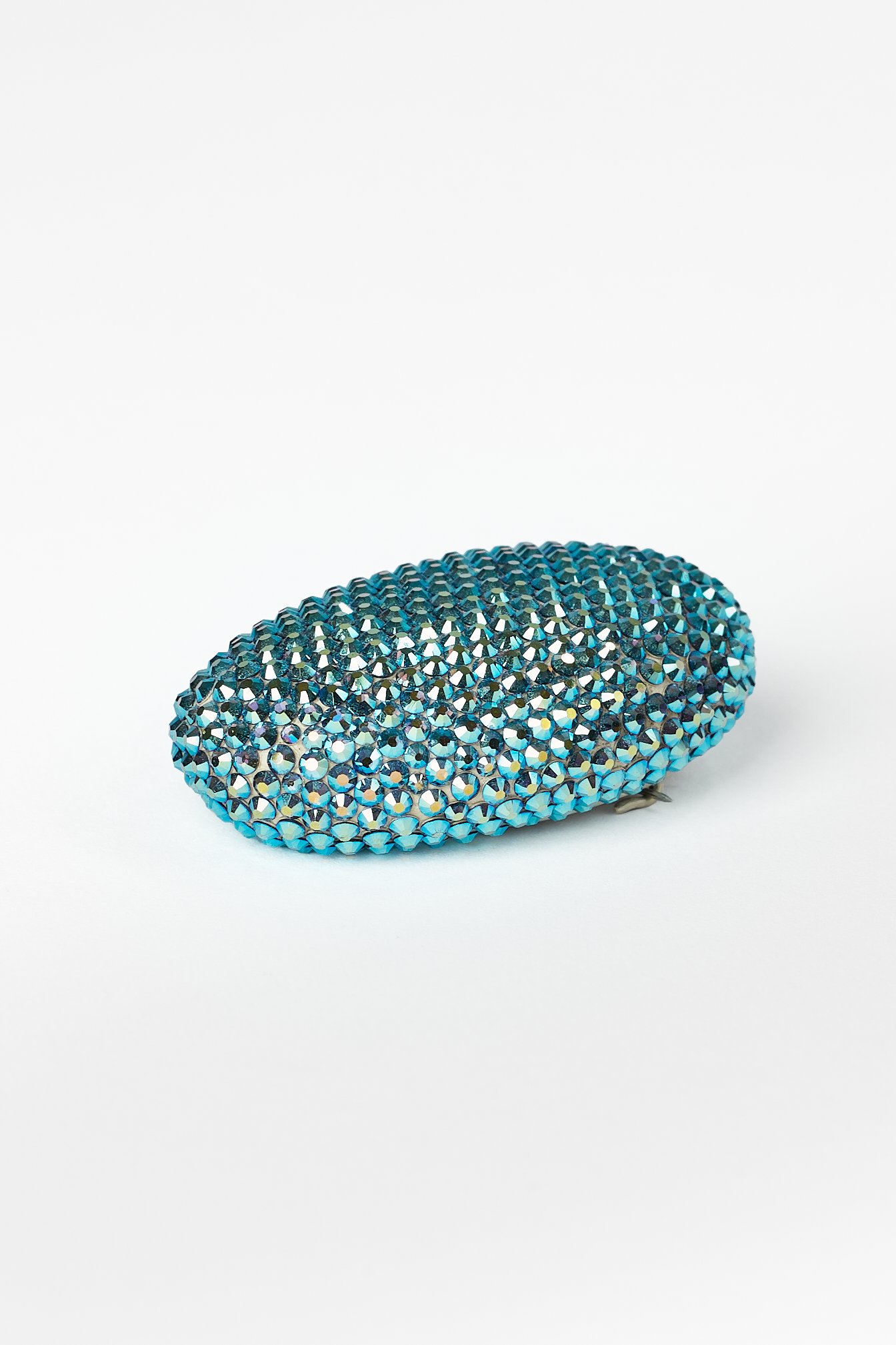 34. Raewyn Walsh, ‘lil blue’, rhinestone brooch, (oval blue), 2025, found pumice, Preciosa crystals, sterling silver, stainless steel wire, 6x2x4cm. Price: $390.