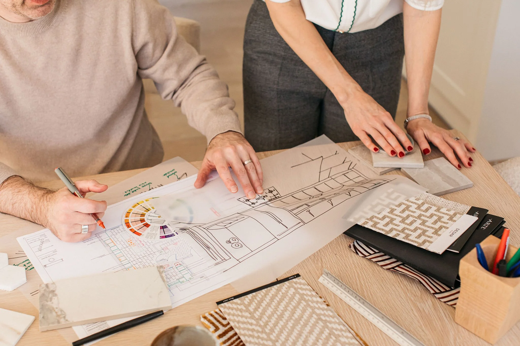 When to hire an interior designer? Andy at Chapter Seven Design reviewing a drawing during the design phase of a residential renovation.