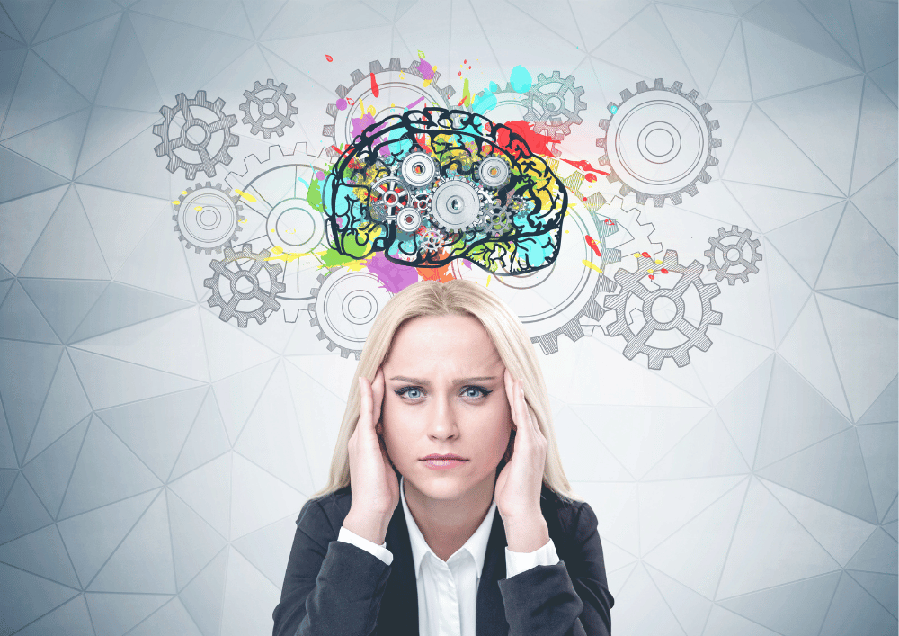 stressed woman with a colourful brain full of cogs above her