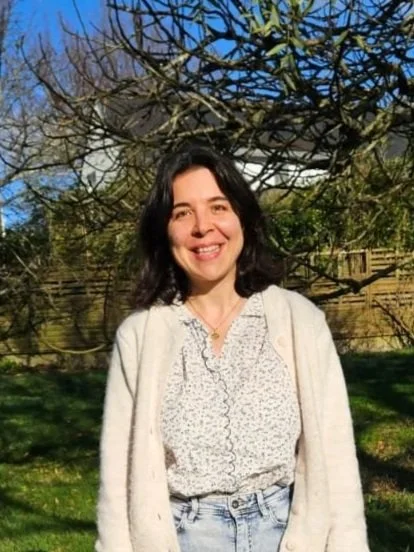 Accountability and french language coach smiling outdoors, providing guidance and support for professional development