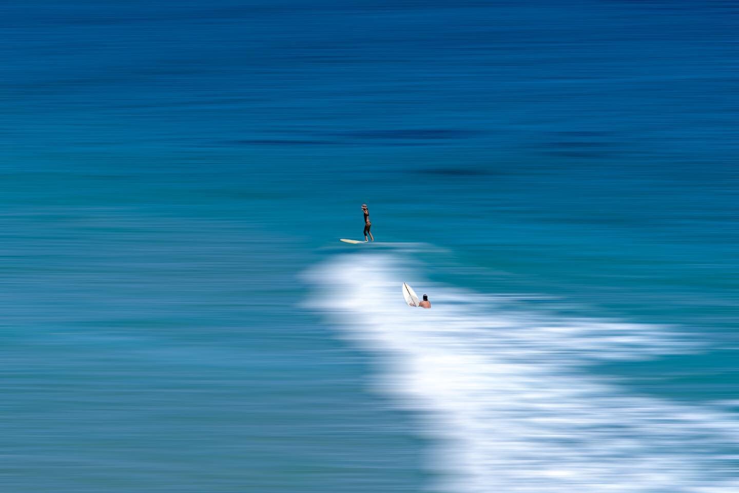 The art of simplicity or the good old truth..

My initial idea was to only delete some surfers to cleanup the photo. But I decided to continue and create the faded ocean around the 2 as well.

Looking back at the 3 images I still don't know which one