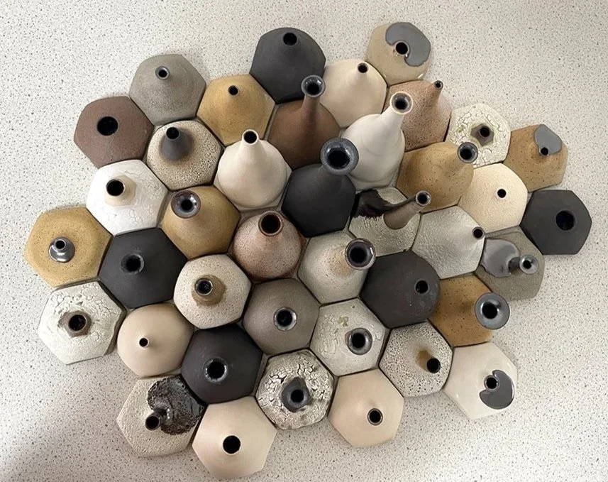 Arial view of collection of thrown bottle forms varying in height and colour that when tessellated together form a ceramic landscape