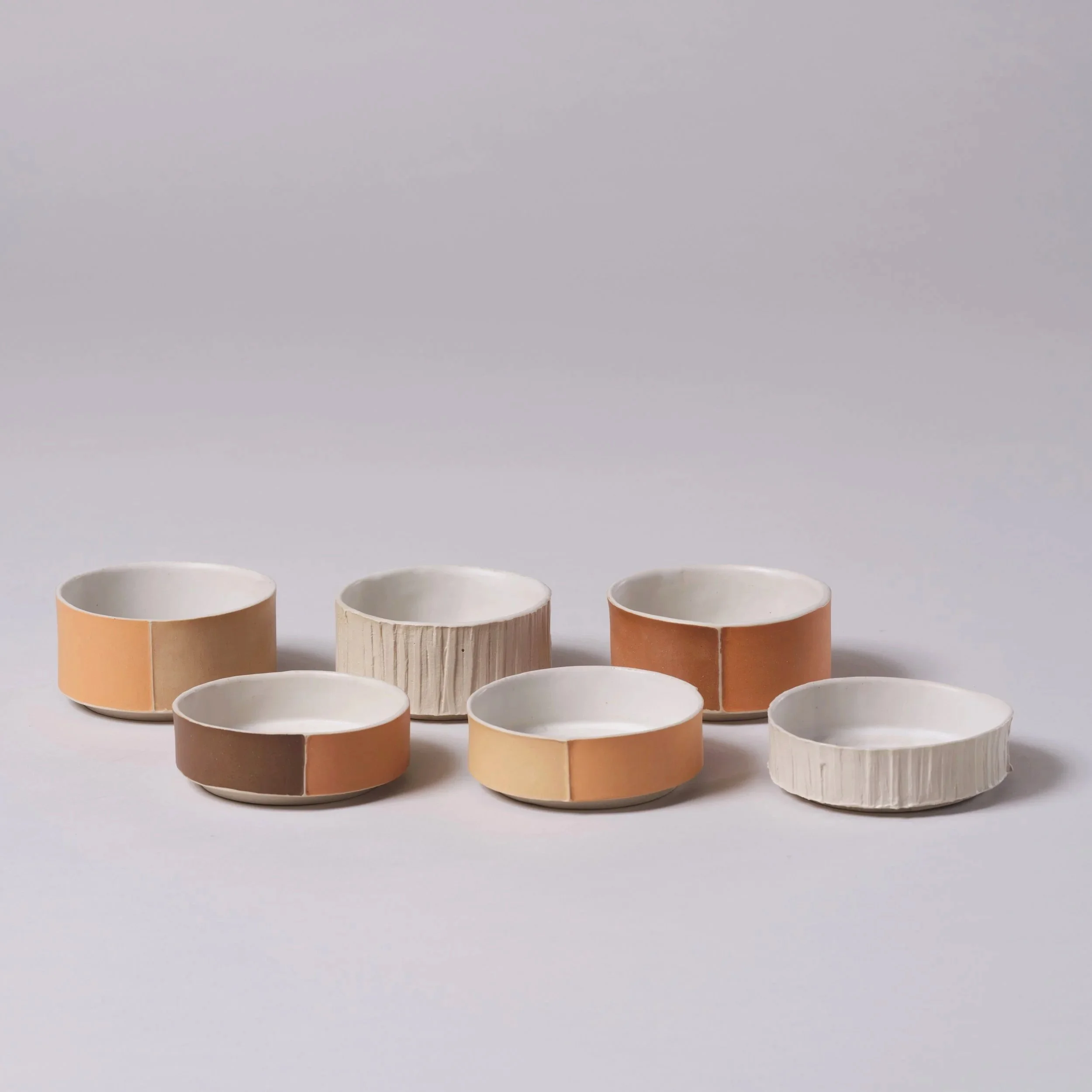 Full range of coloured and textured slipcast contemporary Brutalist inspired ceramic stackable dishes