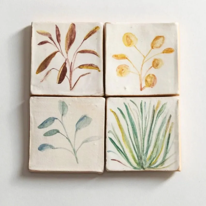 Plant painted tiles with botanical illustrations of different plants on handmade tiles