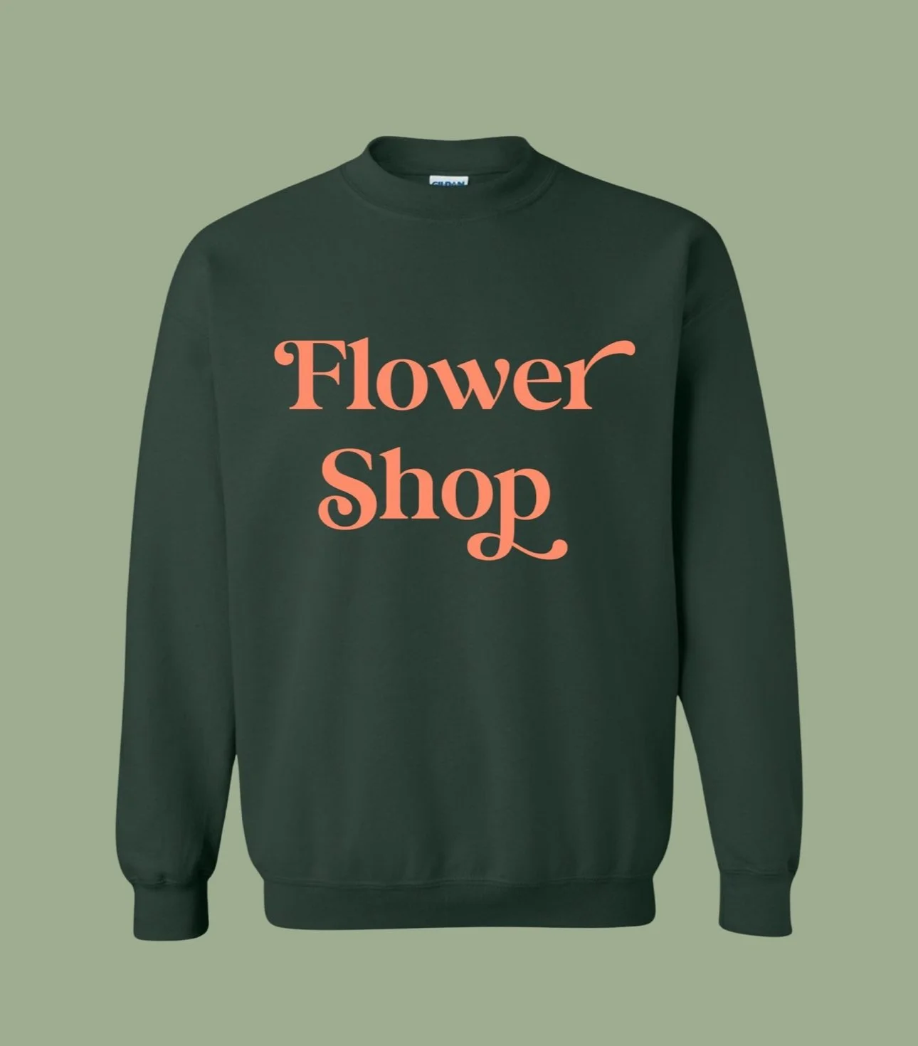 Green sweatshirt with peach-colored text that says "Flower Shop" on the front.