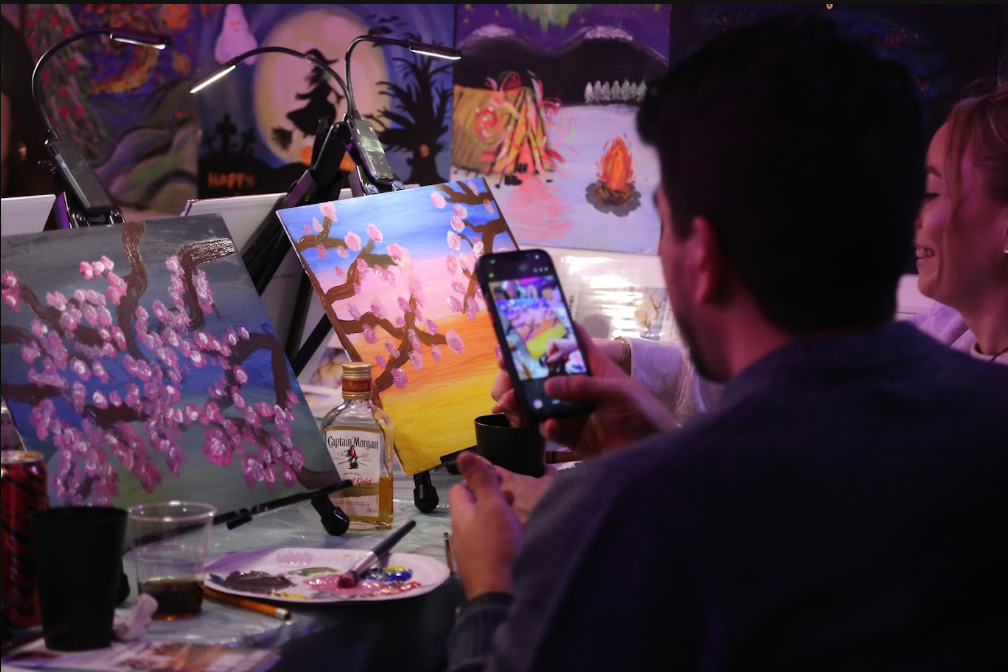 Man taking picture of his artwork