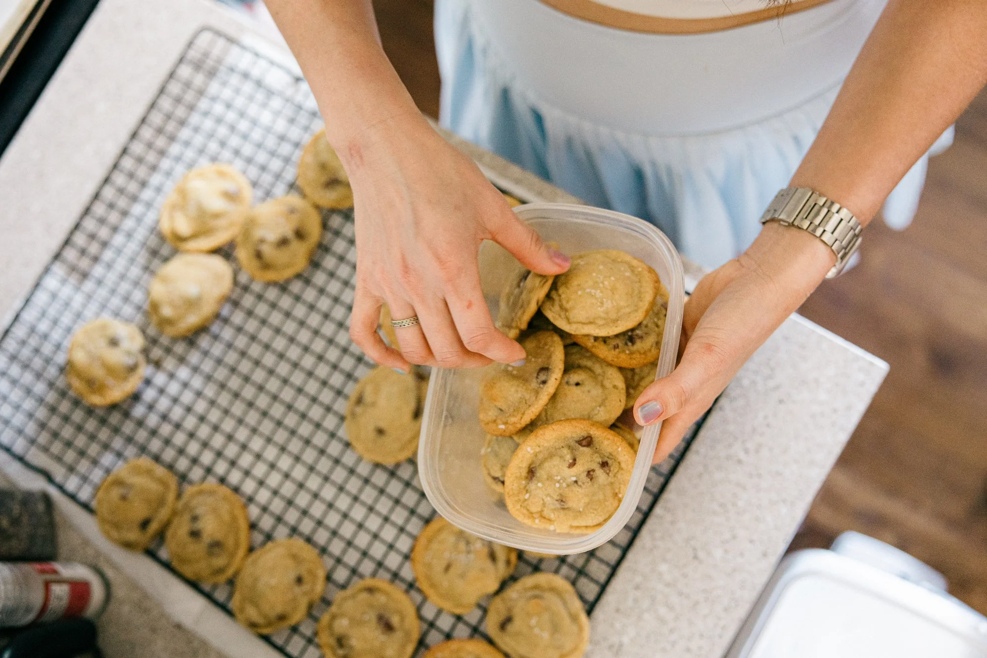 Mom sneaking a taste of cookie dough in the kitchen, candid moment captured during a documentary family photography session by Mel Usry Photography, Northern Virginia