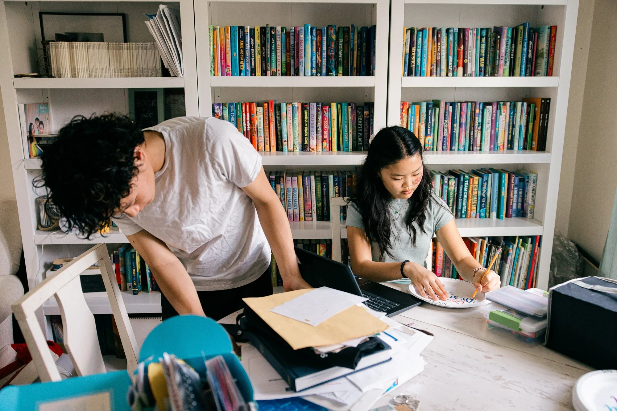 Family photos with older kids captured at home — teenage daughter working on a craft project during a documentary family session, Mel Usry Photography, Northern Virginia