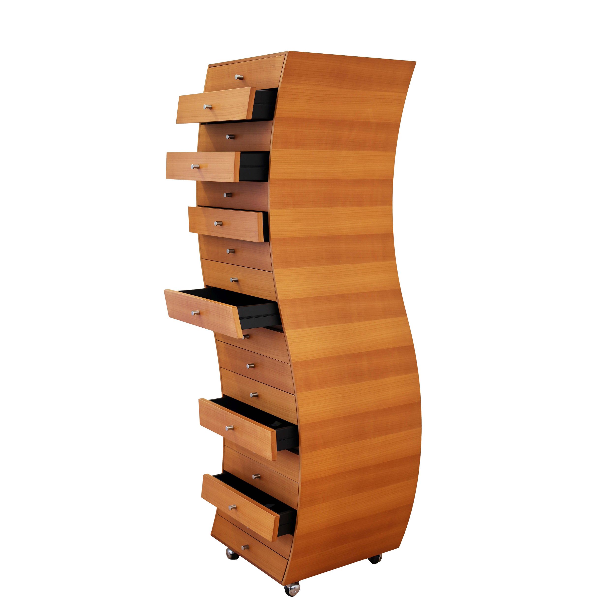 A tall wooden dresser with a curved design, multiple drawers with silver knobs, some of which are open showing black interiors, and small caster wheels at the bottom.