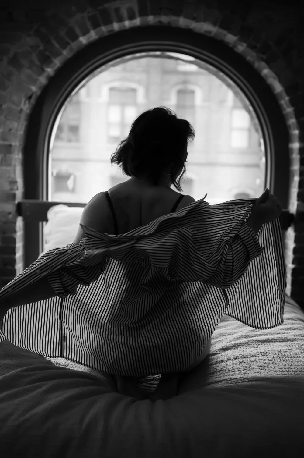 Dark and elegant boudoir session focusing on self-love in Seattle in white button down shirt