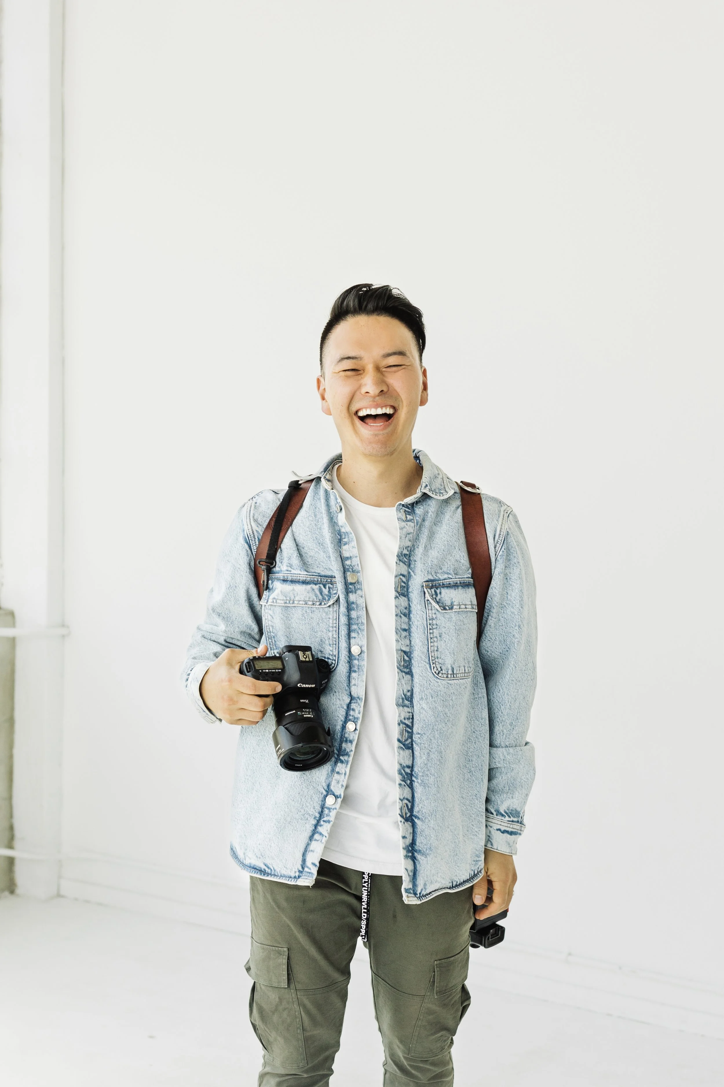 smiling videographer holding camera