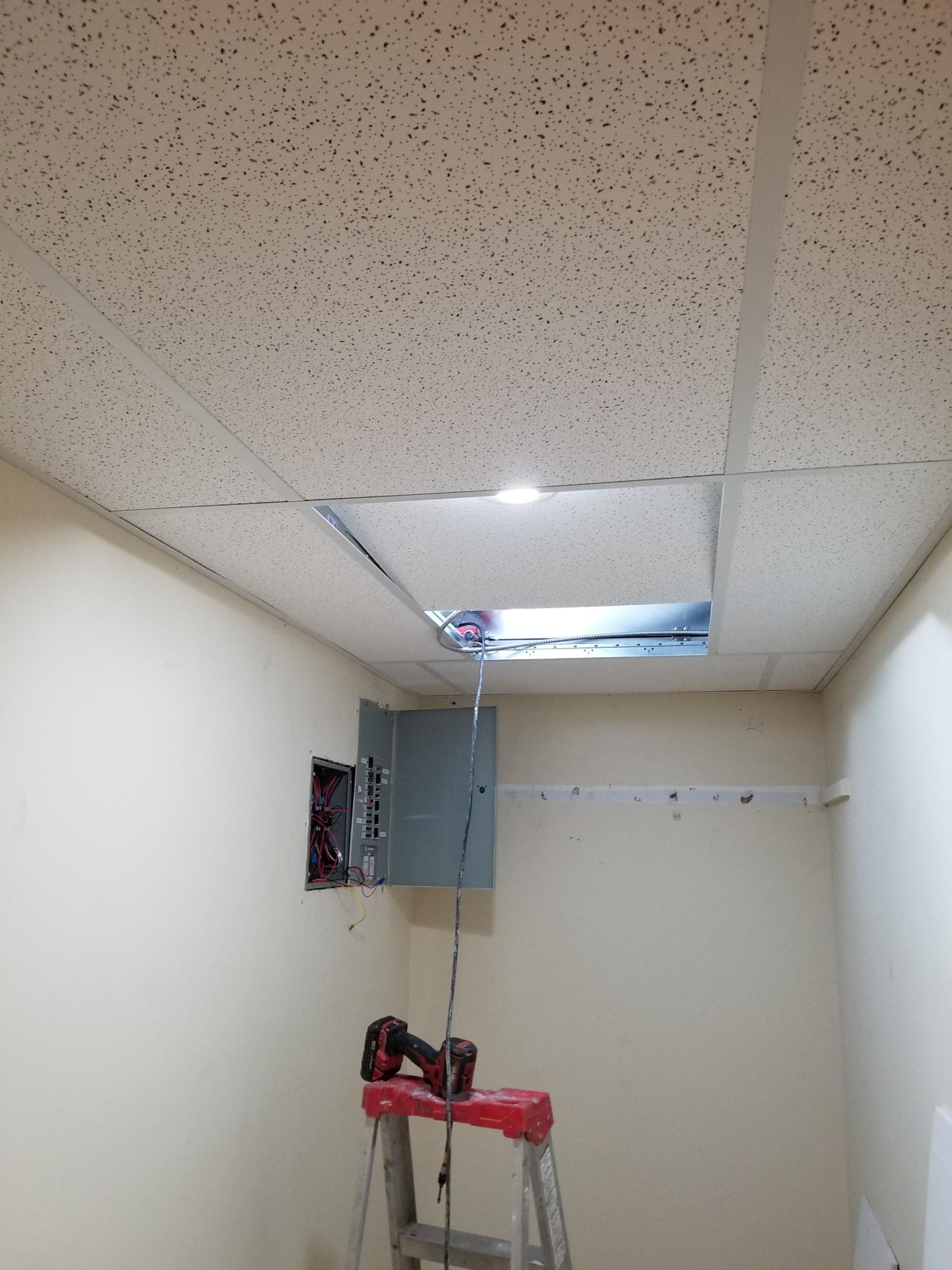 After: newly installed ACT ceiling dropped to accommodate the in-suite ERV and fan coil units.