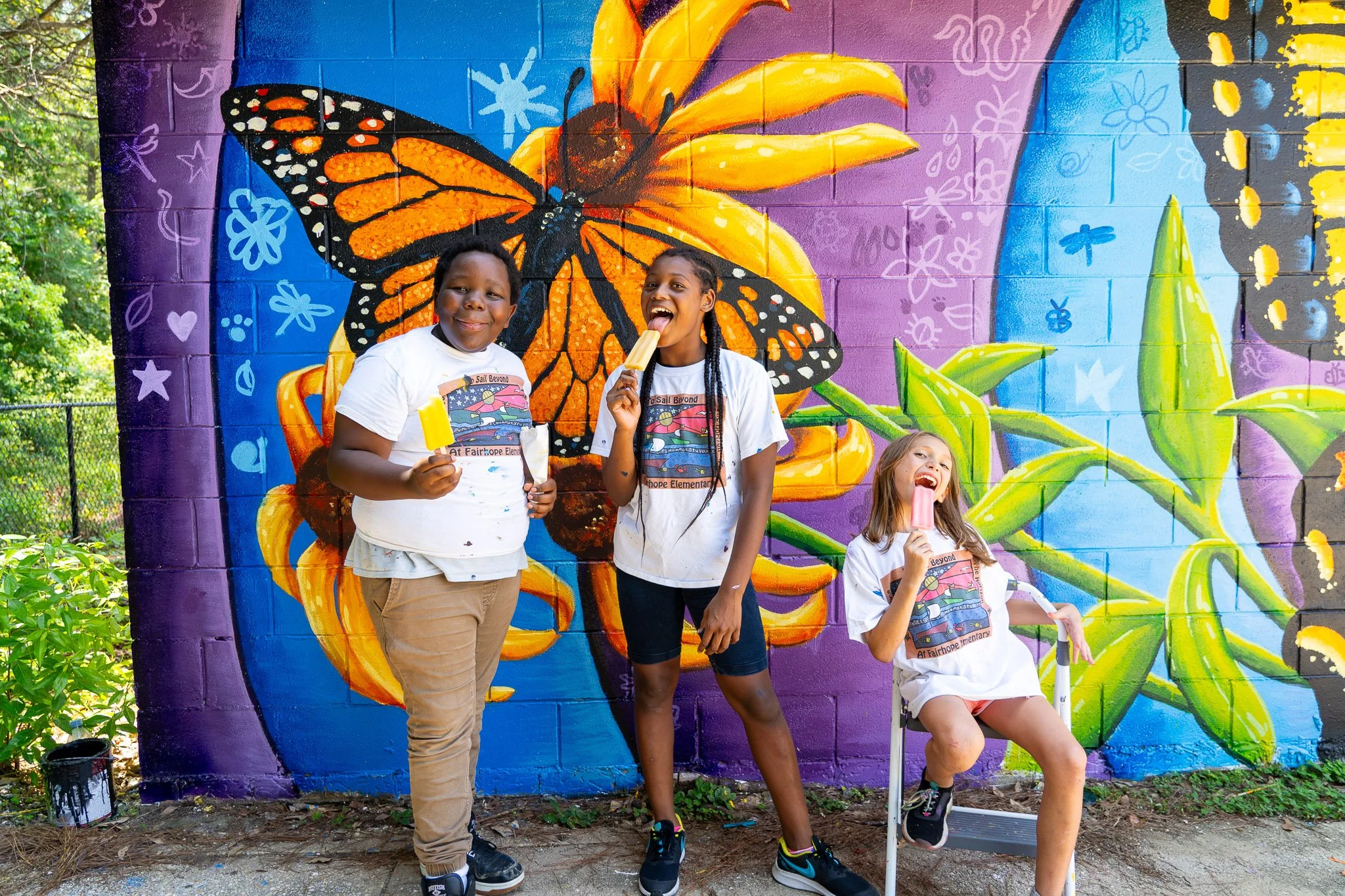 Children in front of a collaborative butterfly and garden mural by Banks Compton at the Rotary Youth Club near Fairhope, Alabama.