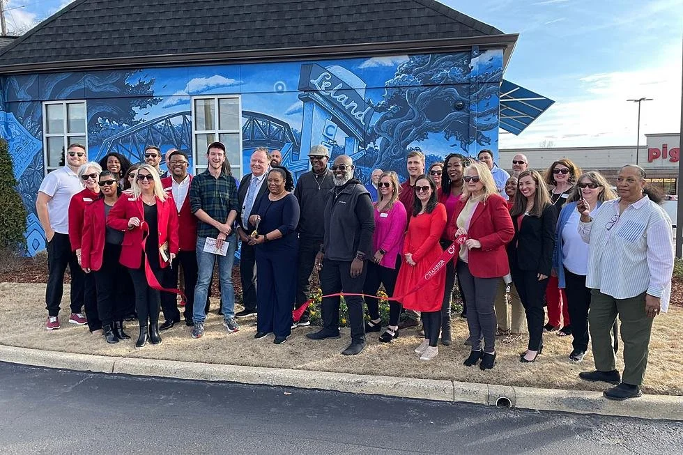Community members gathered in front of Banks Compton's Alabama ONE mural celebrating Alberta City history in Tuscaloosa, Alabama.