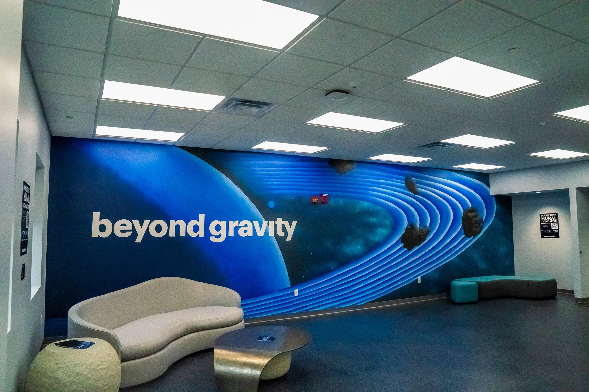 Corporate mural by Banks Compton at Beyond Gravity in Decatur, Alabama, featuring a space-themed design with dimensional asteroid elements.