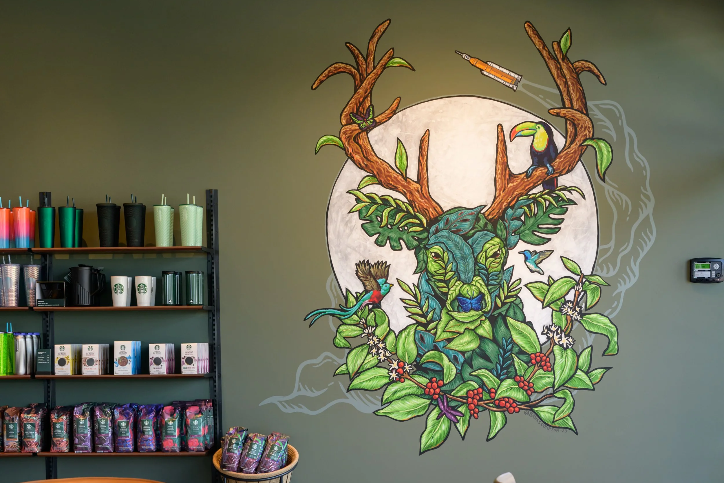 Starbucks mural by Banks Compton in Huntsville, Alabama, combining coffee plants, wildlife, the moon, and Artemis space imagery.