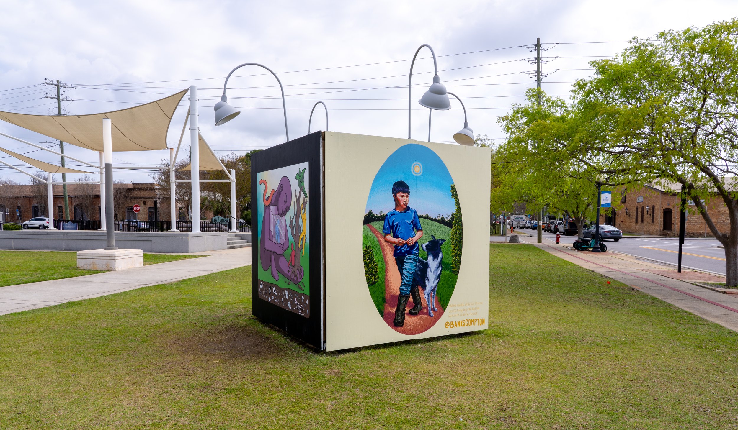 CUBED public art installation by Banks Compton in downtown Pensacola, Florida, depicting a boy and Border Collie walking through a rural Alabama landscape.