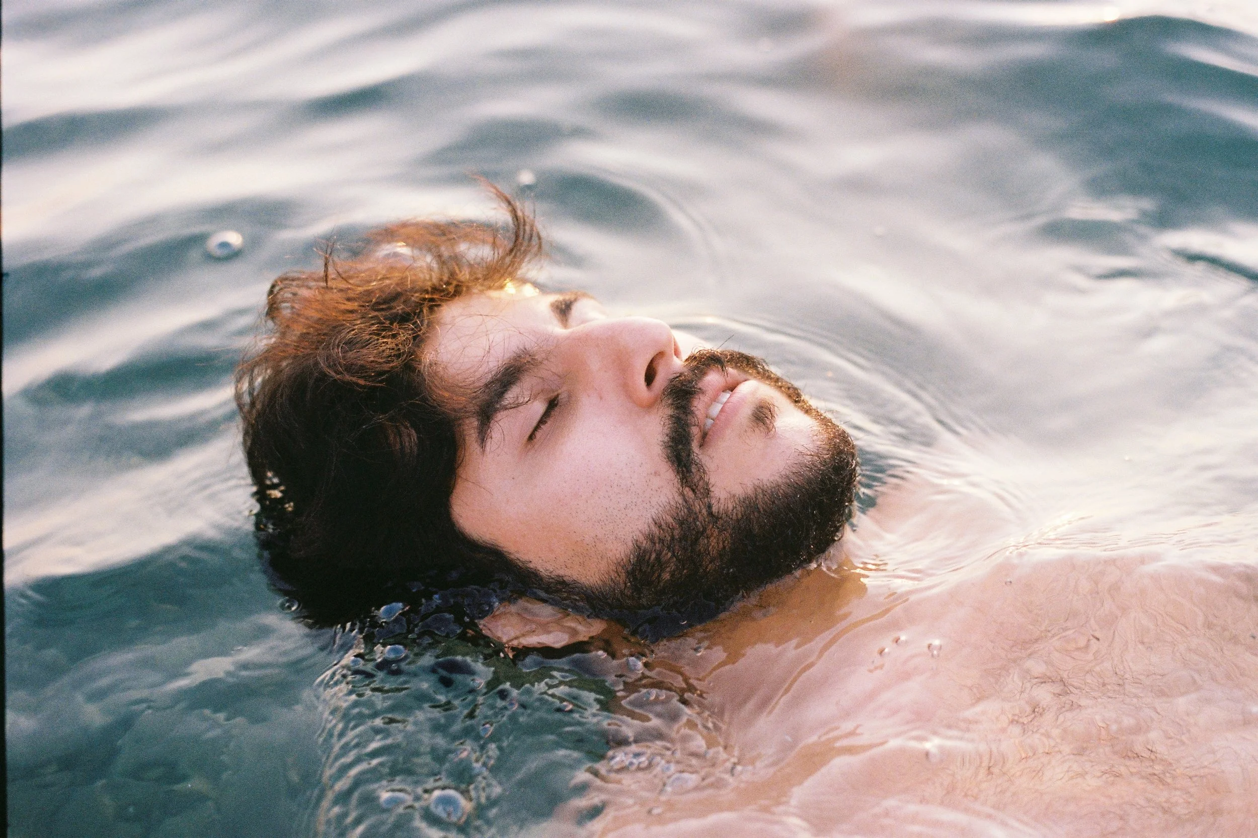 I make friends with Sergen, a tattoo artist from Istanbul. He shows me a portrait he likes of a man in water, and says he wishes he had something like this for an album he would like to release. I tell him we can take it right there in the sea, and w