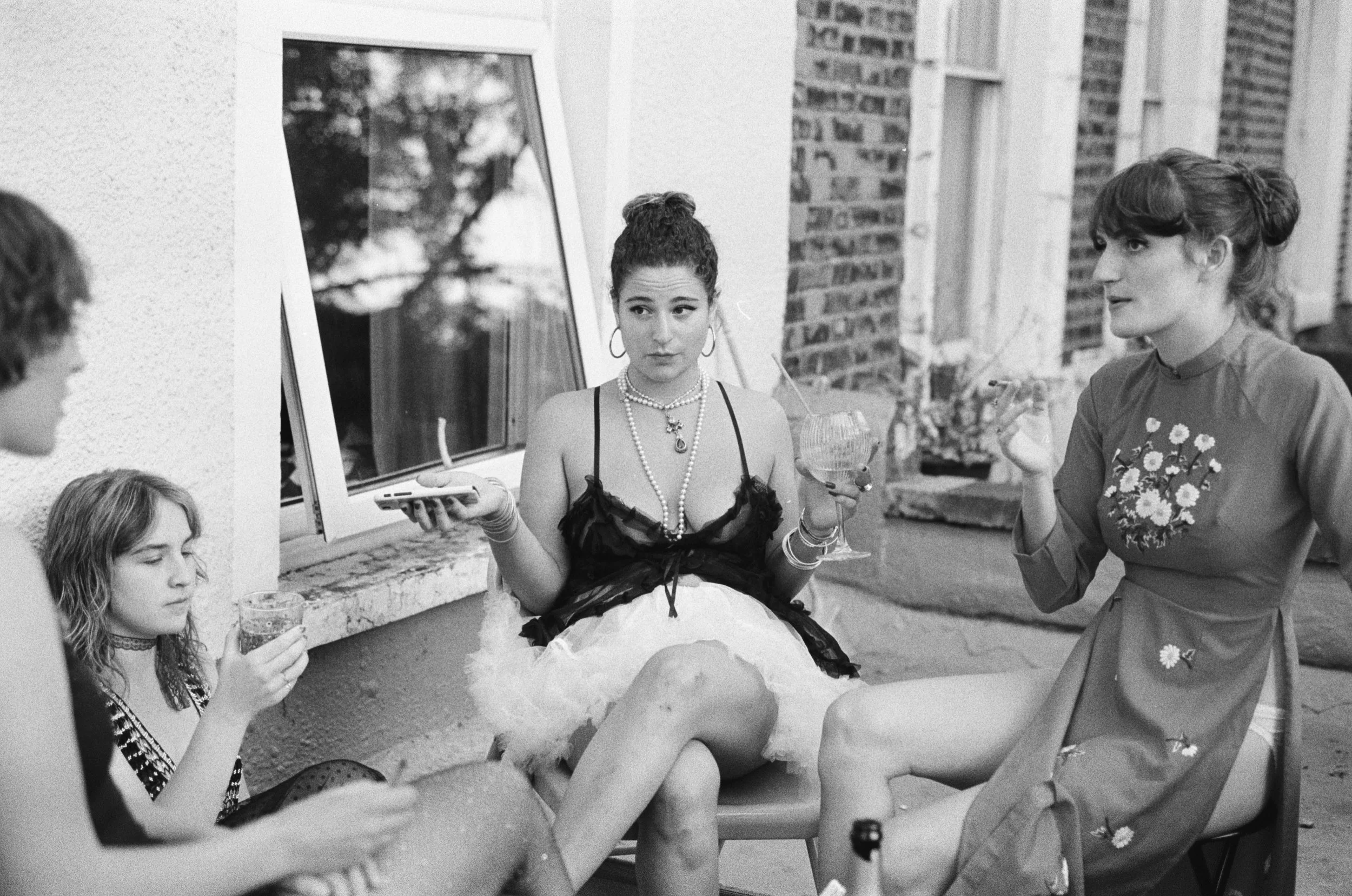 The night of The Barbara. We put up the lights and covered the apartment in Hana's prints. Her friends come early and we drink and smoke on the ledge outside her bedroom window. Somehow I feel the pain of opening, as if I'd closed myself and now the 