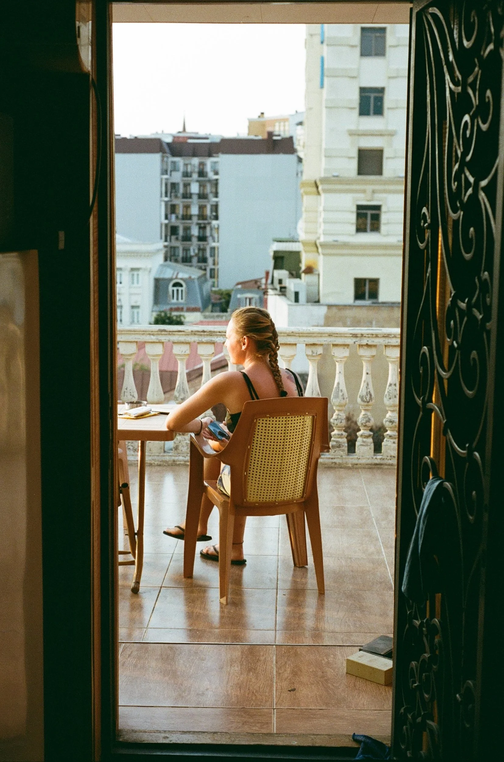 Nastya watching the sun set from the balcony in Batumi. 