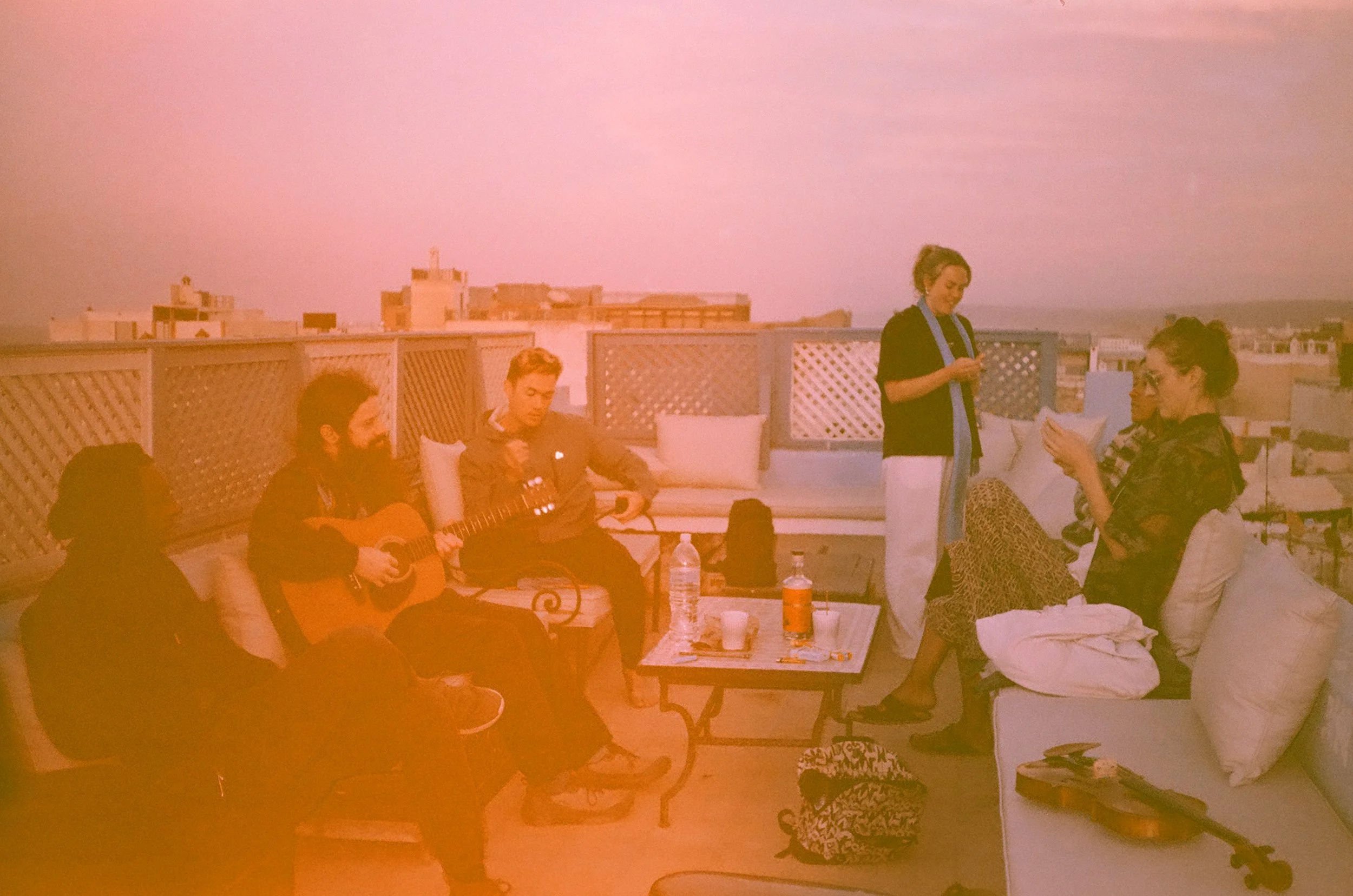 Watching the sun set across the rooftops. Rob plays a mean guitar and has a beautiful voice and I do my best to jam along on my violin. It's a perfect evening I'm in love with everything. 