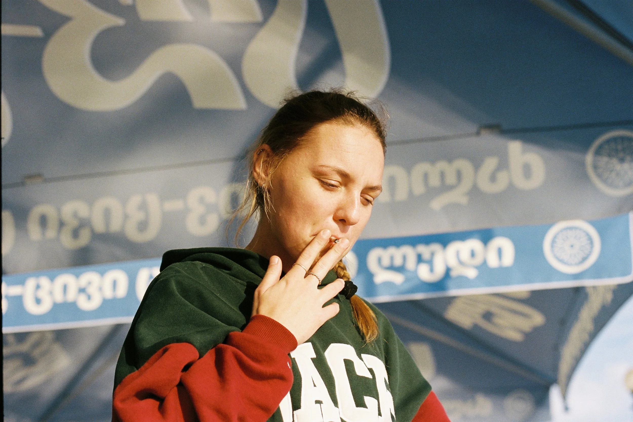 I love the way the water makes patterns with the light under the umbrellas, and the beautiful Georgian writing. I take a million pictures of Nastya as the sun rises.