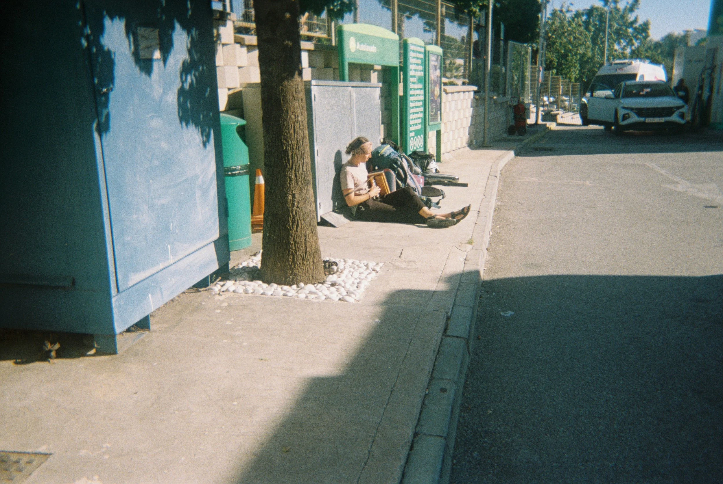 That night, we were couchsurfing in Malaga. Our host drove us further south that morning and let us off here. Salome was sorrowful because she received terrible news, and she played music to help her heart. I take her picture as she plays the Swiss h