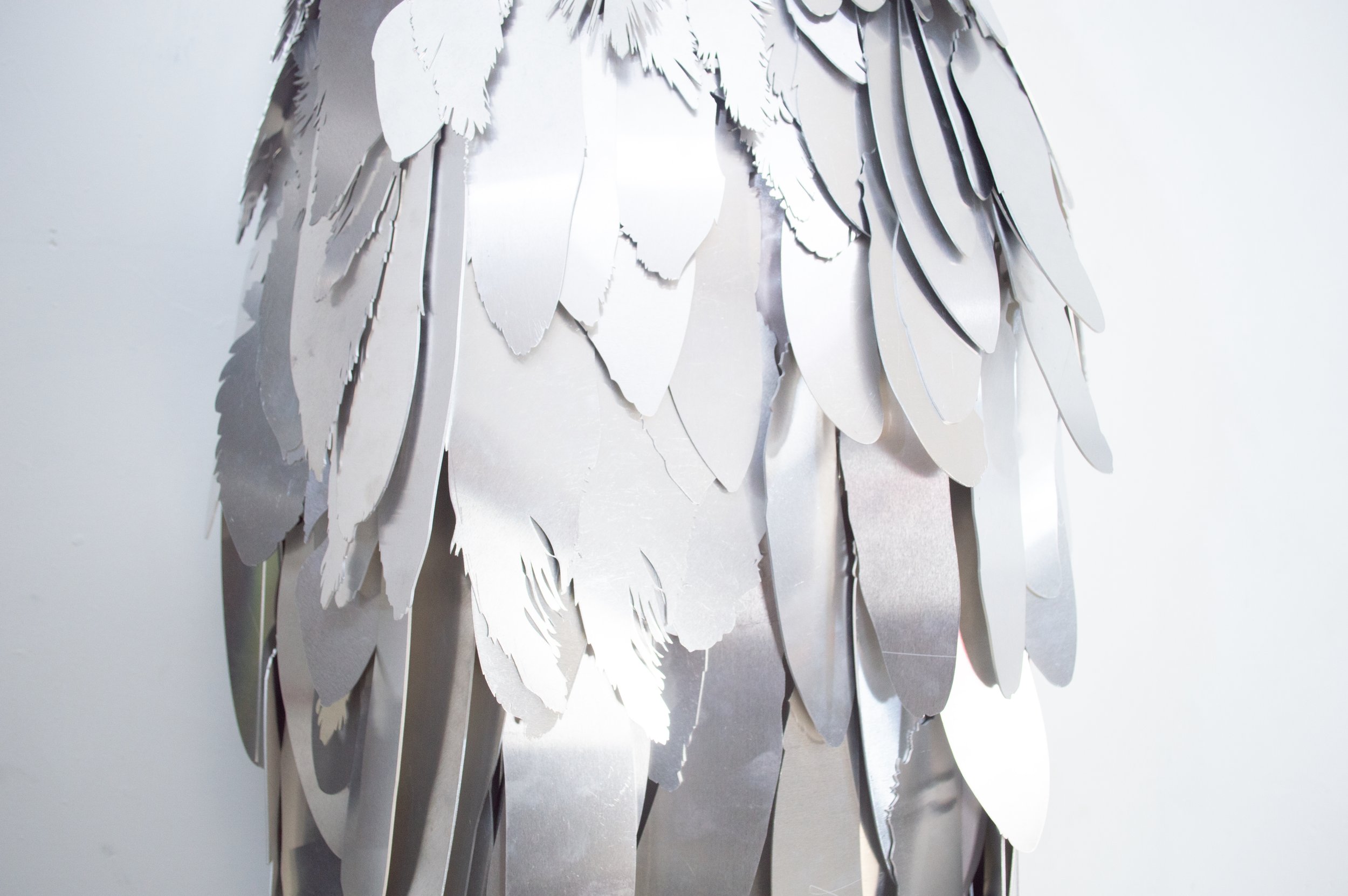 Severin Hallauer, Armour (Leftovers of Salvation), life-sized sculpture composed of aluminium feathers inspired by grey heron plumage. Contemporary sculpture exploring protection, migration, vulnerability, and the promise of escape.