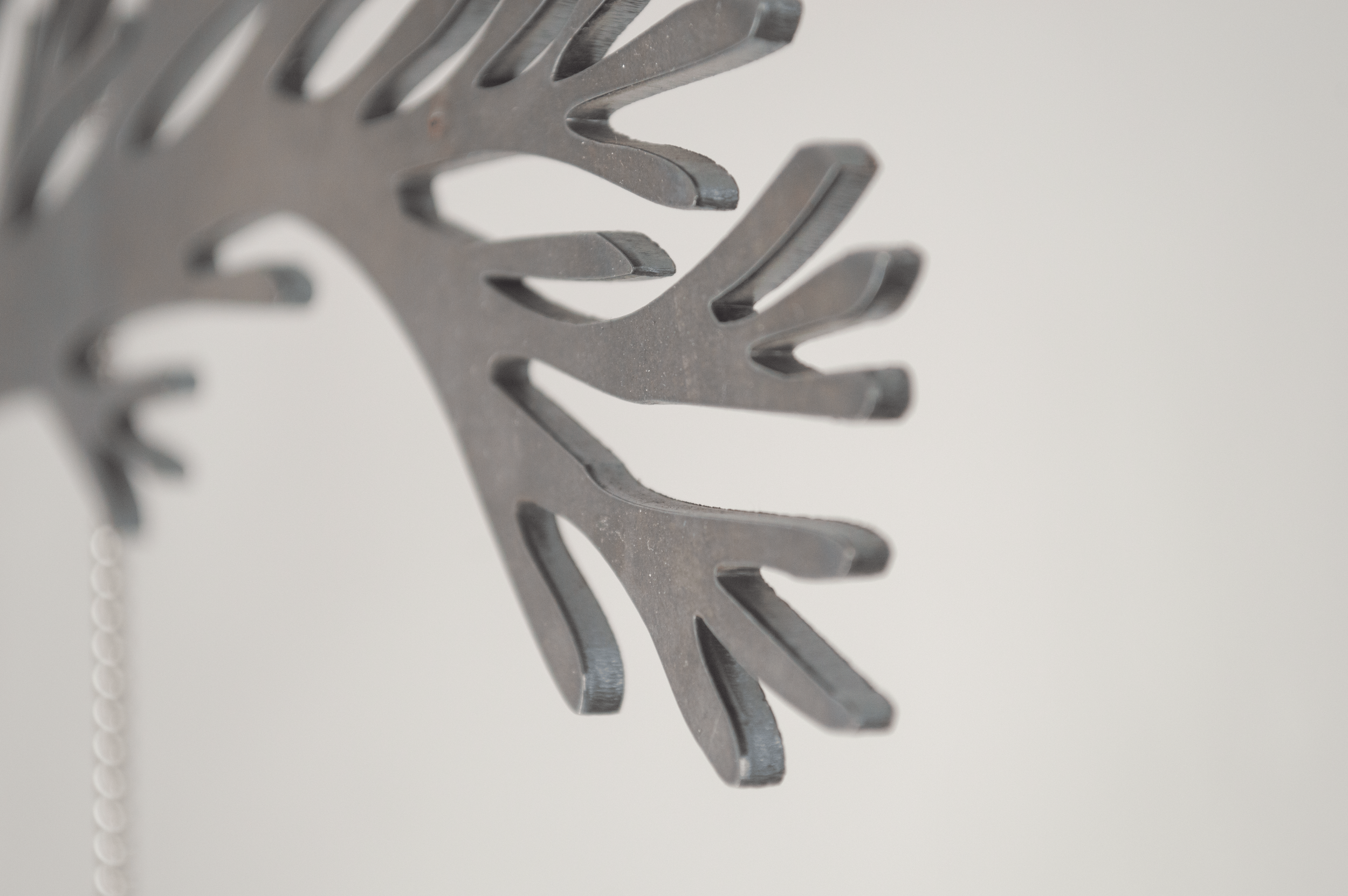 Severin Hallauer, Repeat, 2026. Wall-mounted sculpture in steel, engraved glass, and ceramic exploring family memory, inheritance, and intergenerational trauma.