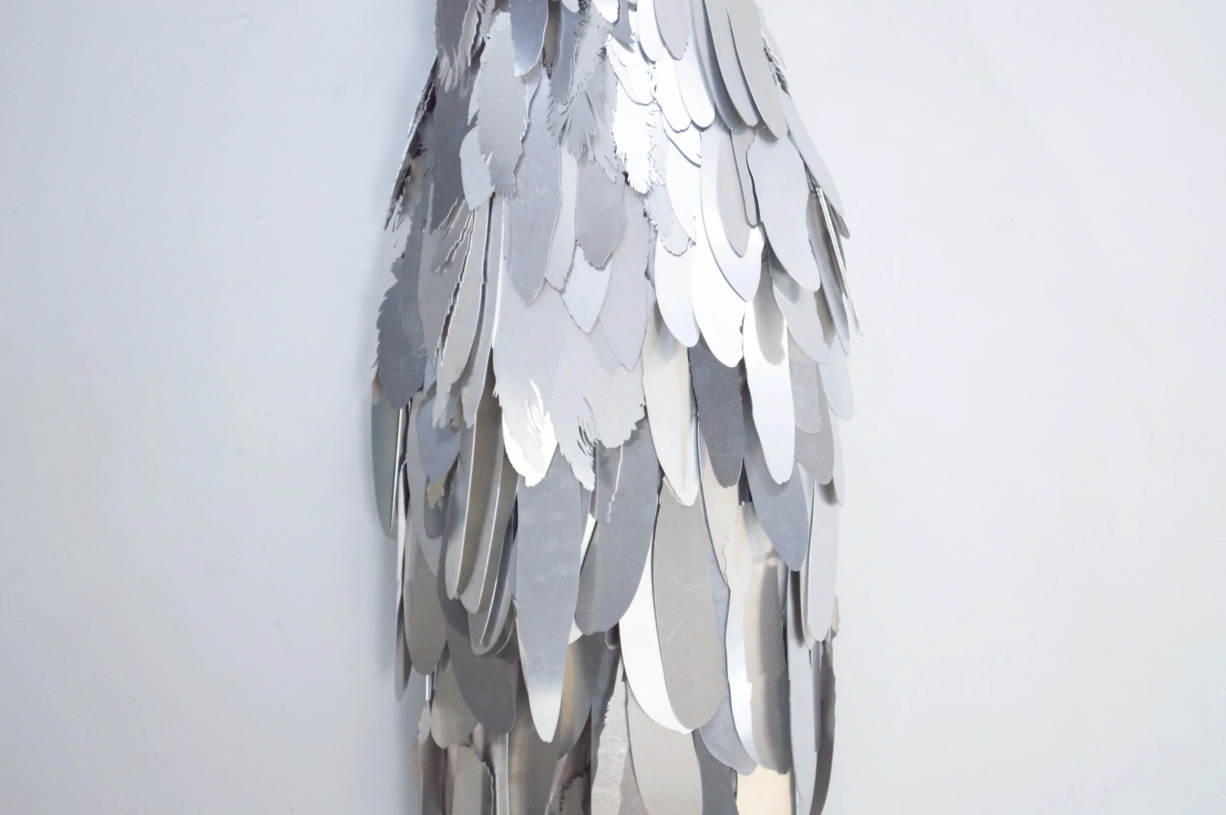 Severin Hallauer, Armour (Leftovers of Salvation), life-sized sculpture composed of aluminium feathers inspired by grey heron plumage. Contemporary sculpture exploring protection, migration, vulnerability, and the promise of escape.